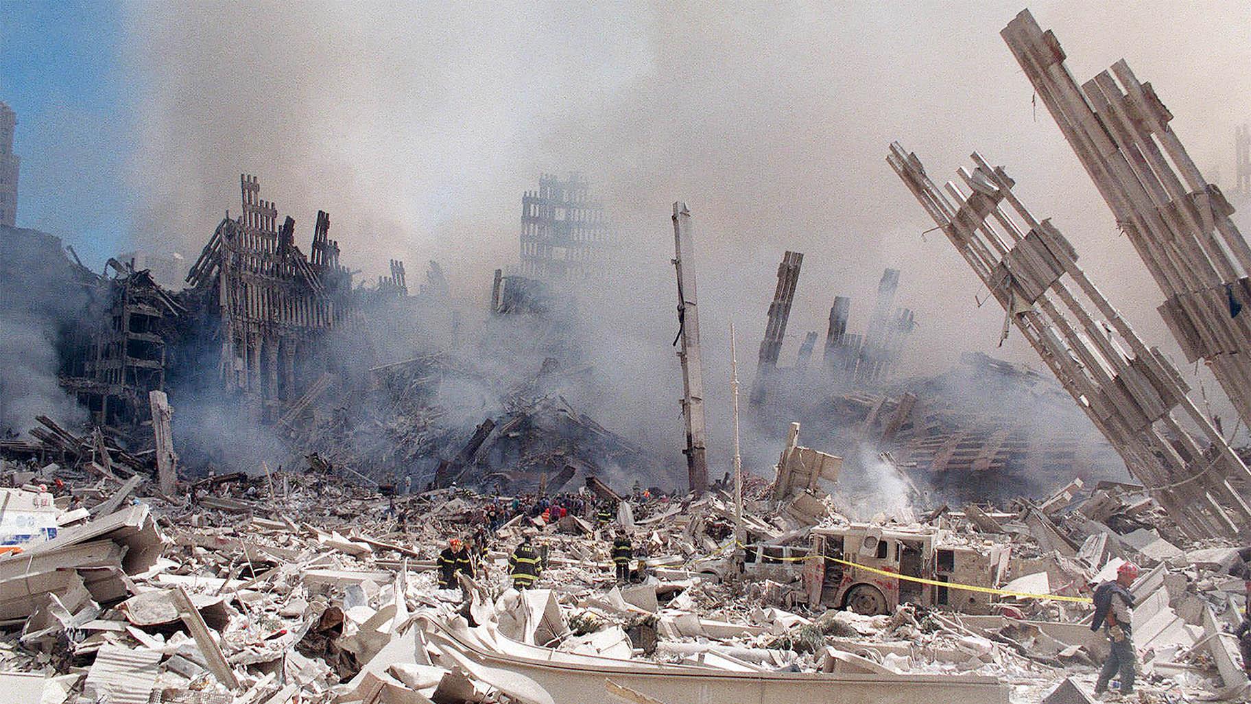 In this Sept. 12, 2001 file photo, firefighters work in the rubble of the World Trade Center towers in New York. (AP Photo / Virgil Case, File)