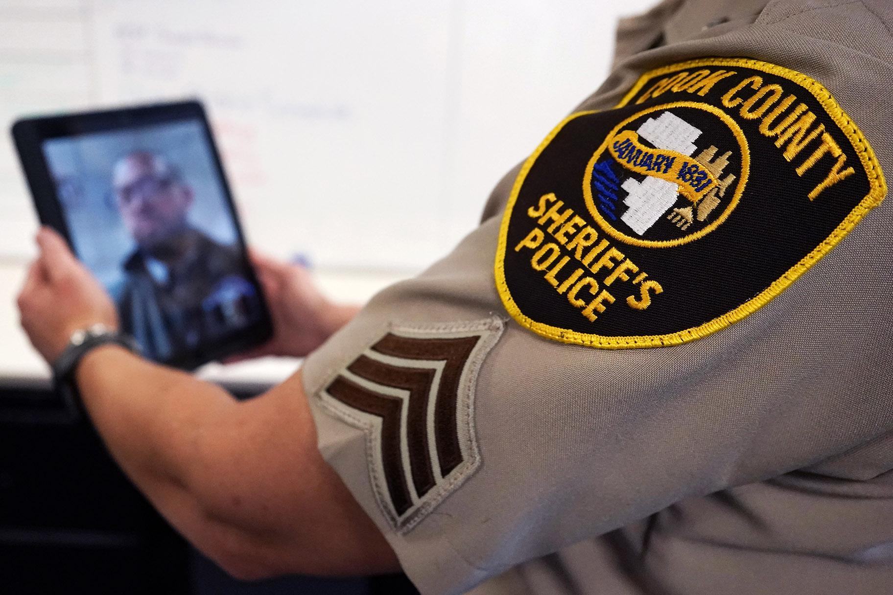 In this Friday, Aug. 13, 2021, photo Sheriff’s Police Sgt. Bonnie Busching tests a virtual meeting with a tablet at the Cook County Sheriff’s Office in Chicago. (AP Photo / Nam Y. Huh)