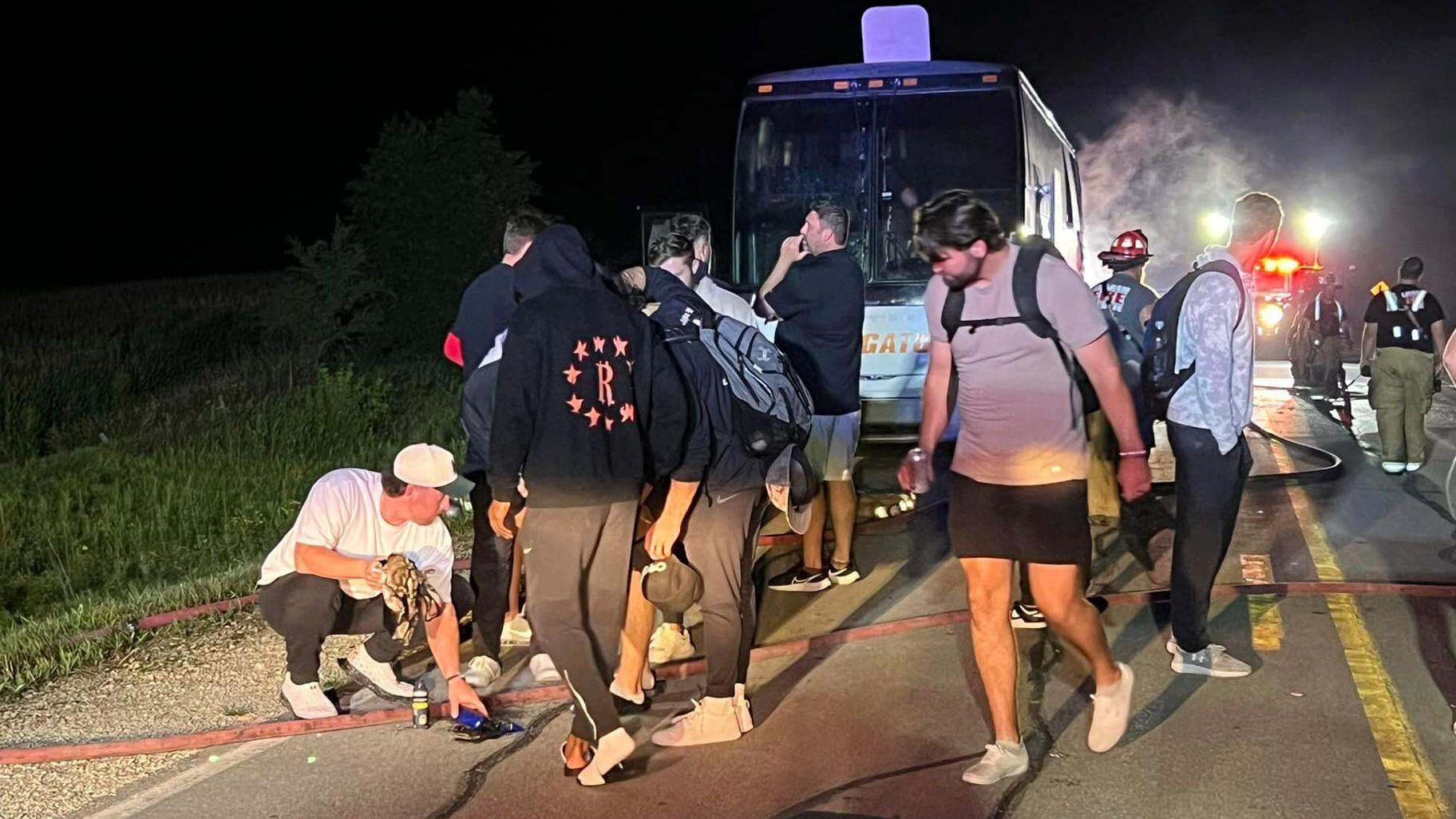 In this photo provided by J.D. Scholten, a bus carrying the Sioux City Explorers to a baseball game in Illinois caught fire early on Friday, Aug. 2, 2024, near Earlham, Iowa. State Rep. J.D. Scholten, who is a pitcher for the team, wrote in a Facebook post that he was grateful no one was hurt. (J.D. Scholten via AP)
