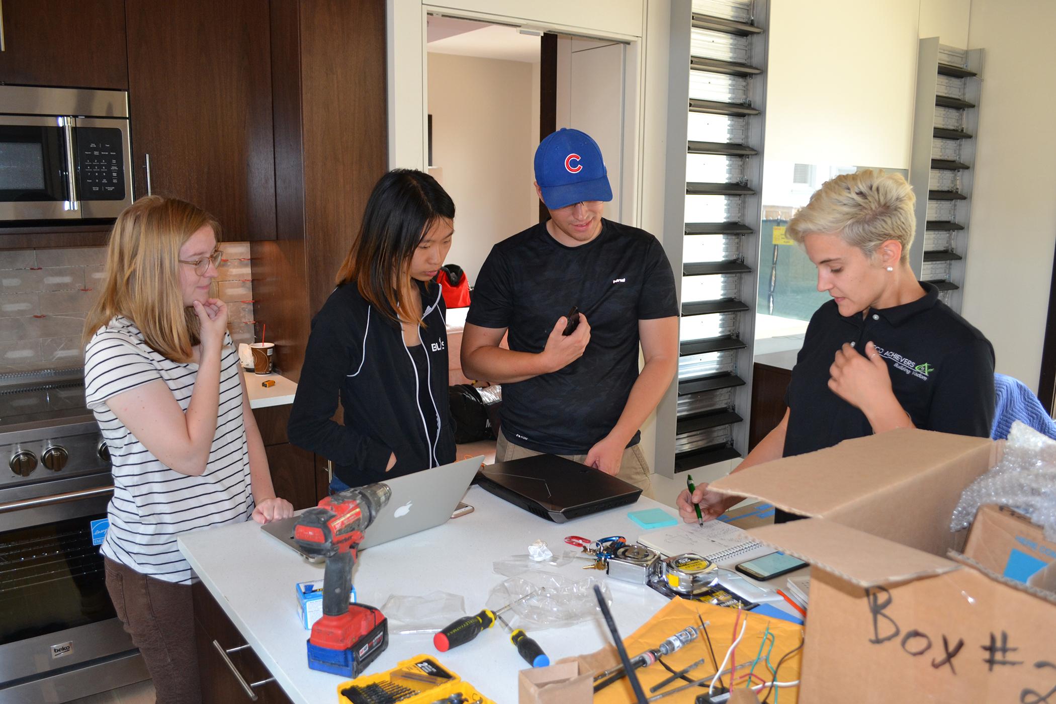 Vivien Ng, second from left, and fellow Northwestern students prepare their solar-powered house for an upcoming energy competition. (Alex Ruppenthal / Chicago Tonight)