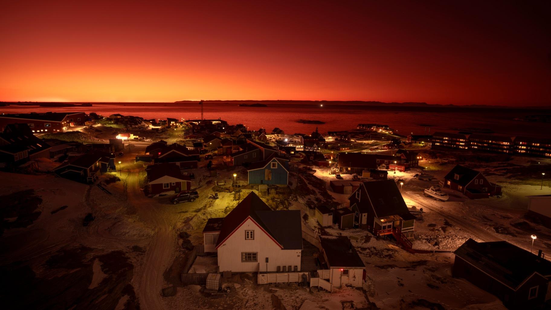 The sun sets in Ilulissat, Greenland, Tuesday, Feb. 18, 2025. (AP Photo / Emilio Morenatti)