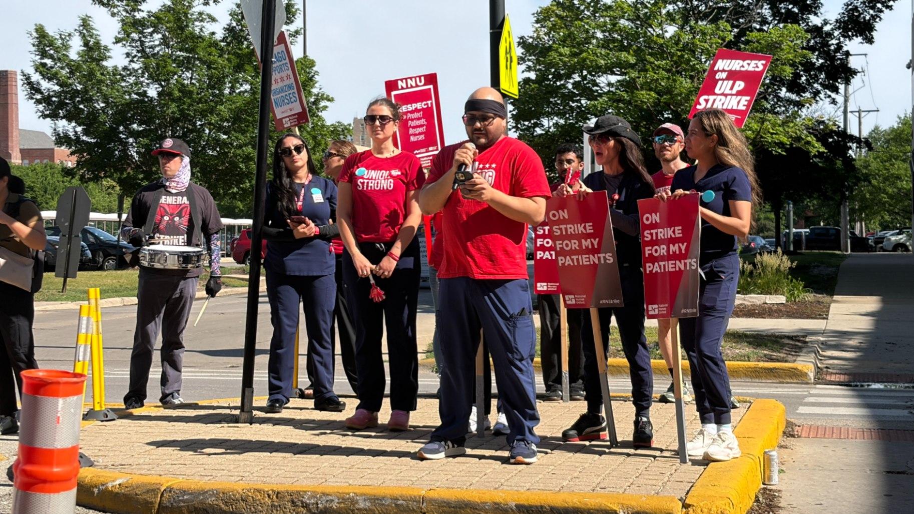 Jesus Hernandez, one of the six fired nurses, speaks during a rally outside Saint Mary of Nazareth Hospital as part of a planned one-day strike on June 11, 2026. (Eunice Alpasan / WTTW News)