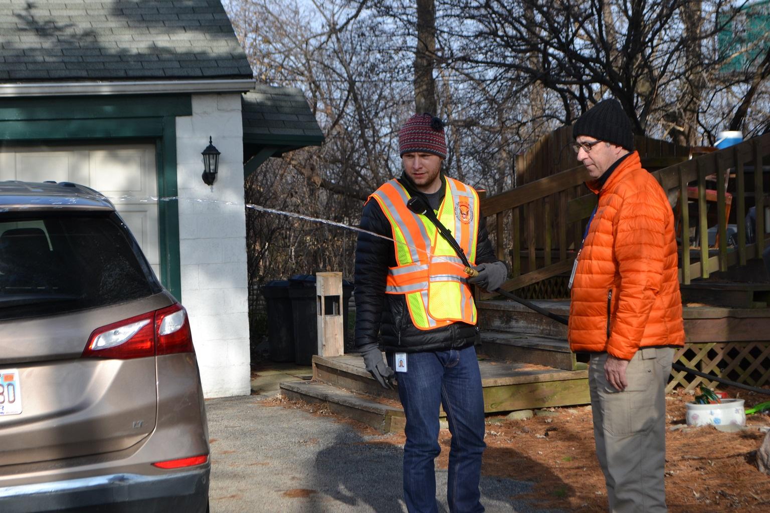 John Berg, an environmental health specialist with the DuPage County Health Department, runs water from a private well in Willowbrook on Thursday as part of testing for levels of cancer-causing ethylene oxide. (Alex Ruppenthal / WTTW)