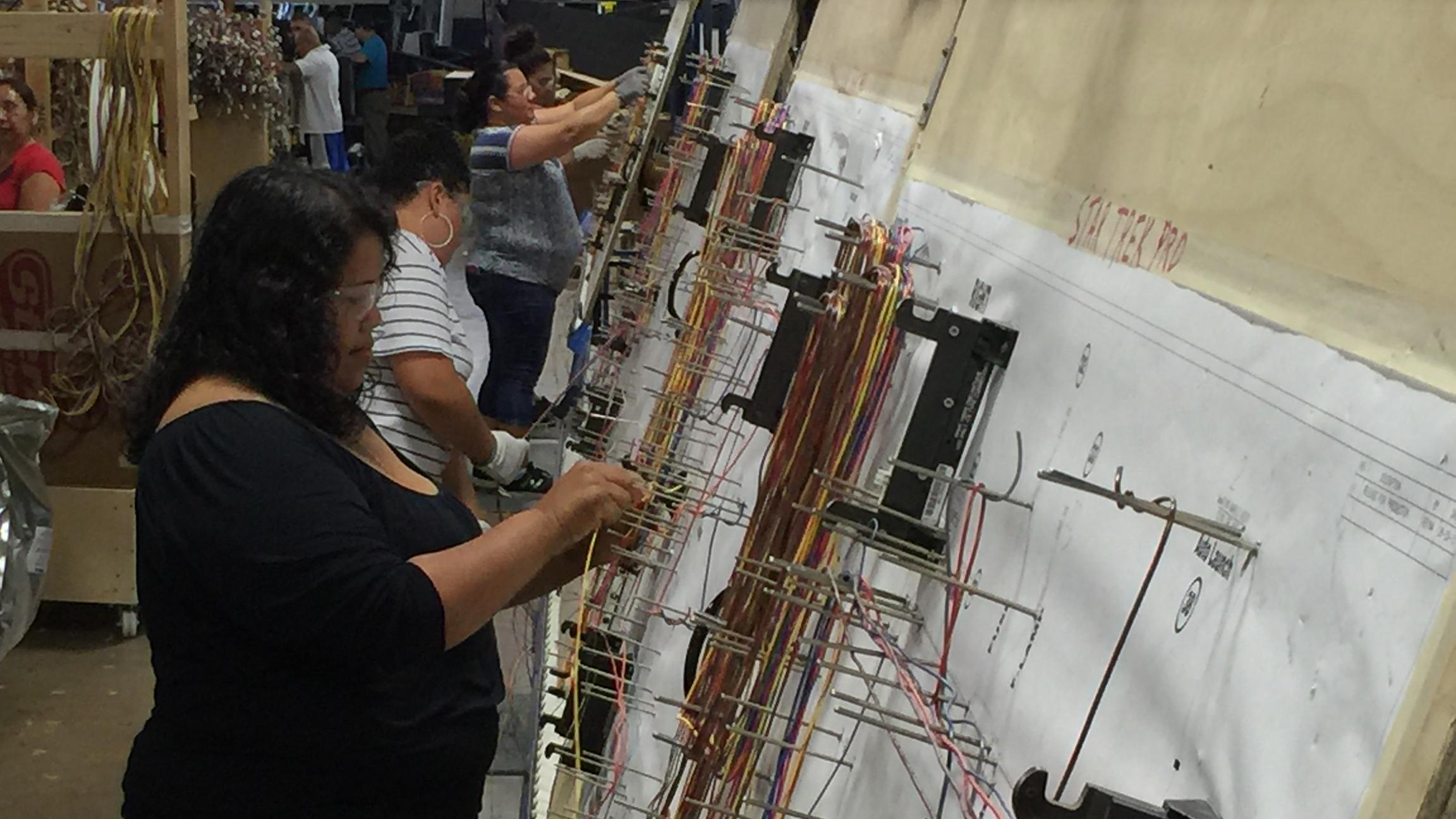 Workers at Stern Pinball do everything from string wire to testing the finished product. (Dan Andries / Chicago Tonight)