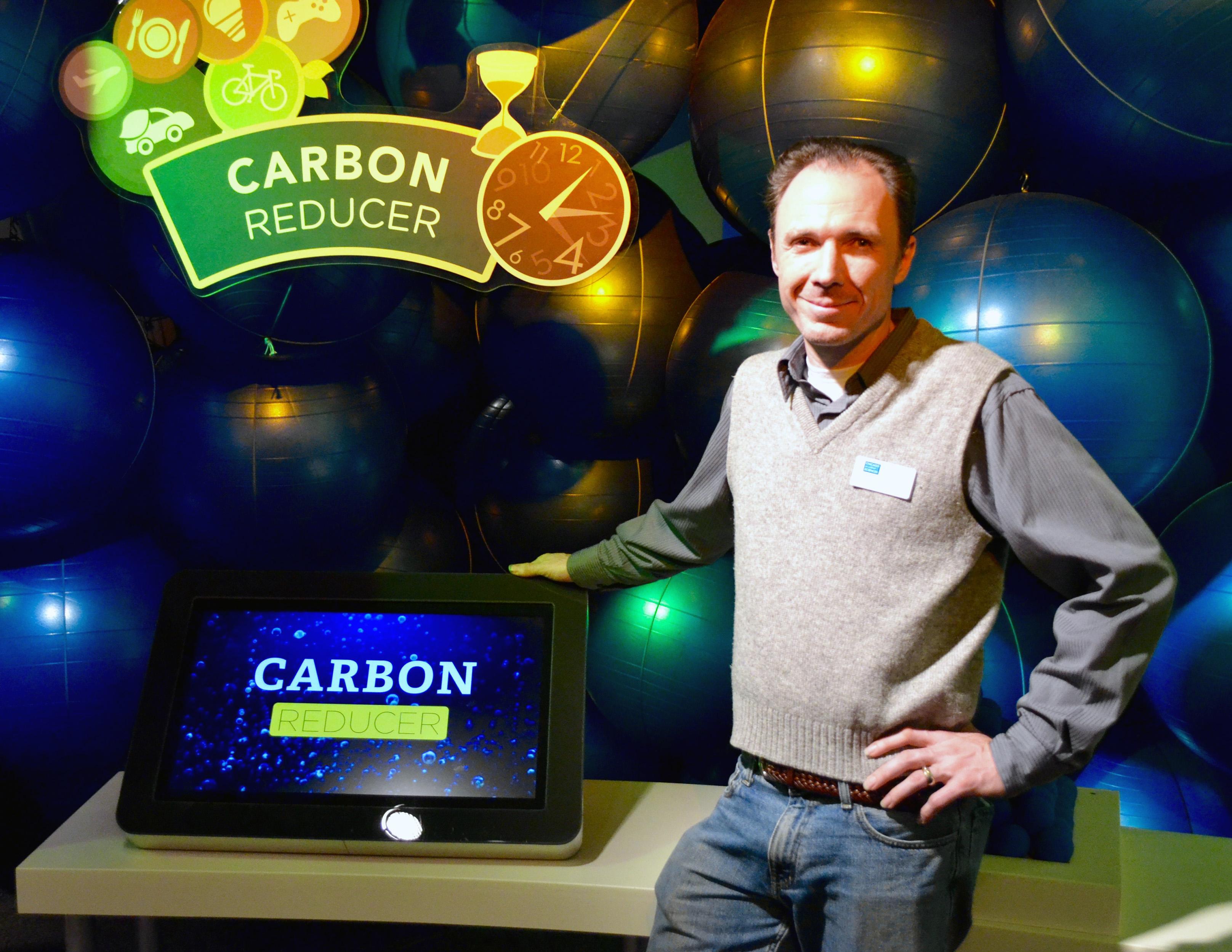 Senior curator Steve Sullivan stands in front of 94 yoga balls that represent the 94 pounds of carbon dioxide, the primary greenhouse gas, the average American emits on a daily basis. (Evan Garcia)