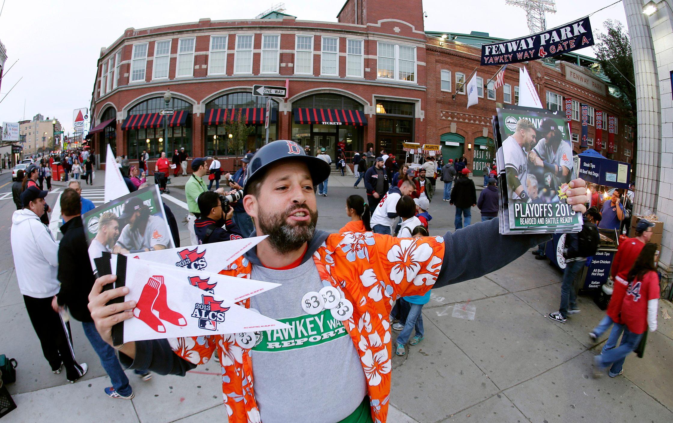 In this Oct. 19, 2013, file photo, Tim Lampa hawks programs and Boston Red Sox pennants outside Fenway Park before Game 6 of the American League baseball championship series between the Red Sox and the Detroit Tigers in Boston. (AP Photo / Charlie Riedel, File)
