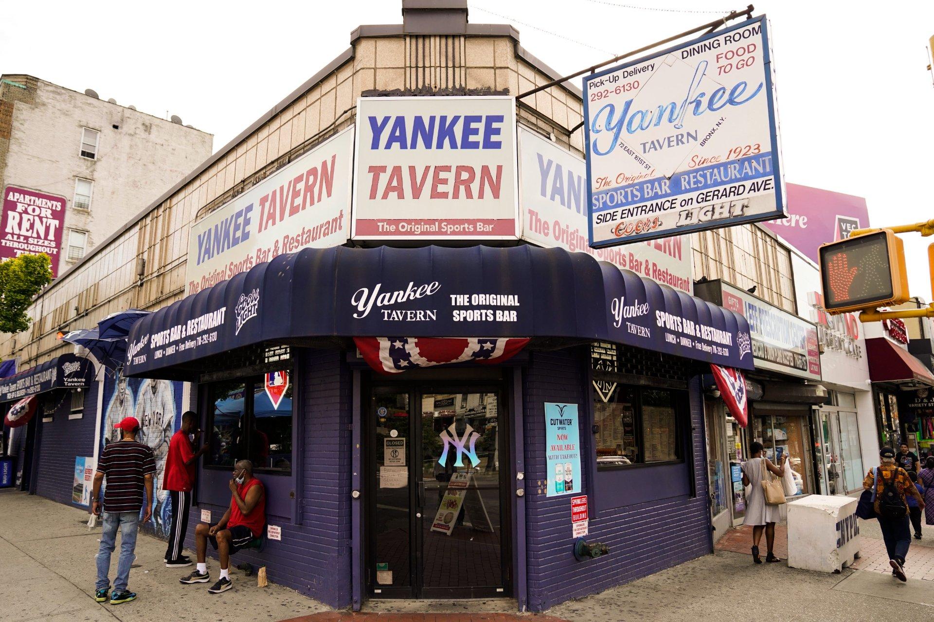 Pedestrians pass the Yankee Tavern, Friday, Aug. 14, 2020, in New York. The tavern has been in business since 1927. (AP Photo / Frank Franklin II)