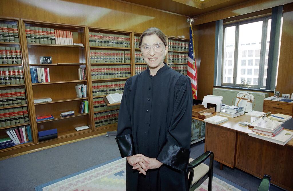 In this Aug. 3, 1993, file photo, then-Judge Ruth Bader Ginsburg poses in her robe in her office at U.S. District Court in Washington. Earlier, the Senate voted 96-3 to confirm Bader as the 107th justice and the second woman to serve on the Supreme Court. (AP Photo / Doug Mills, File)