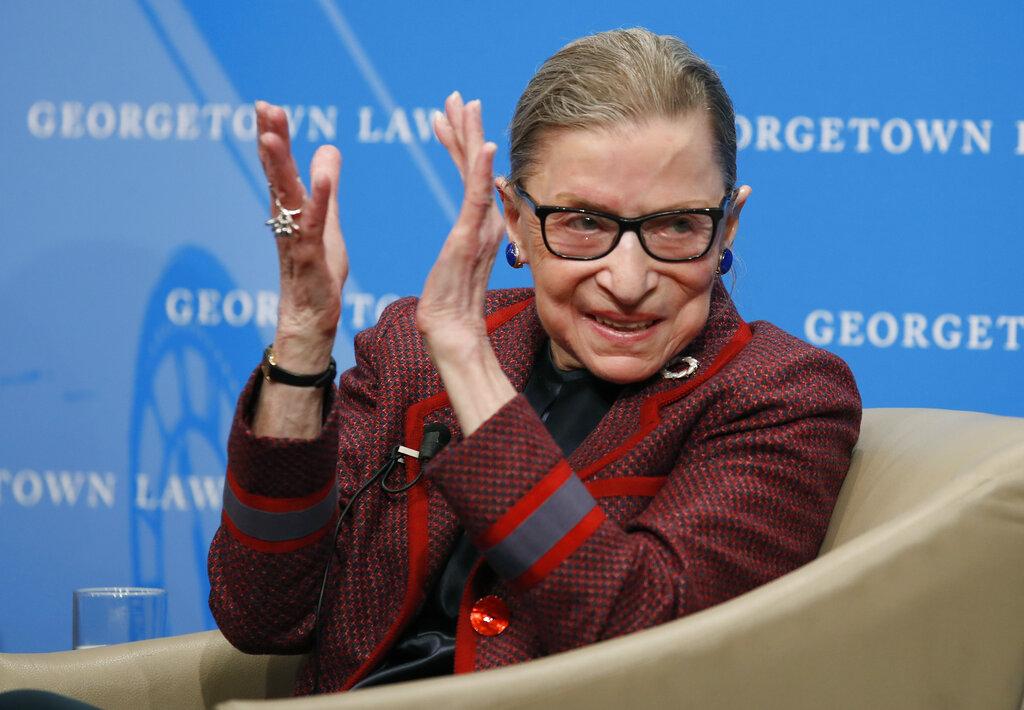 In this April 6, 2018, file photo, Supreme Court Justice Ruth Bader Ginsburg applauds after a performance in her honor after she spoke about her life and work during a discussion at Georgetown Law School in Washington. (AP Photo / Alex Brandon, File)