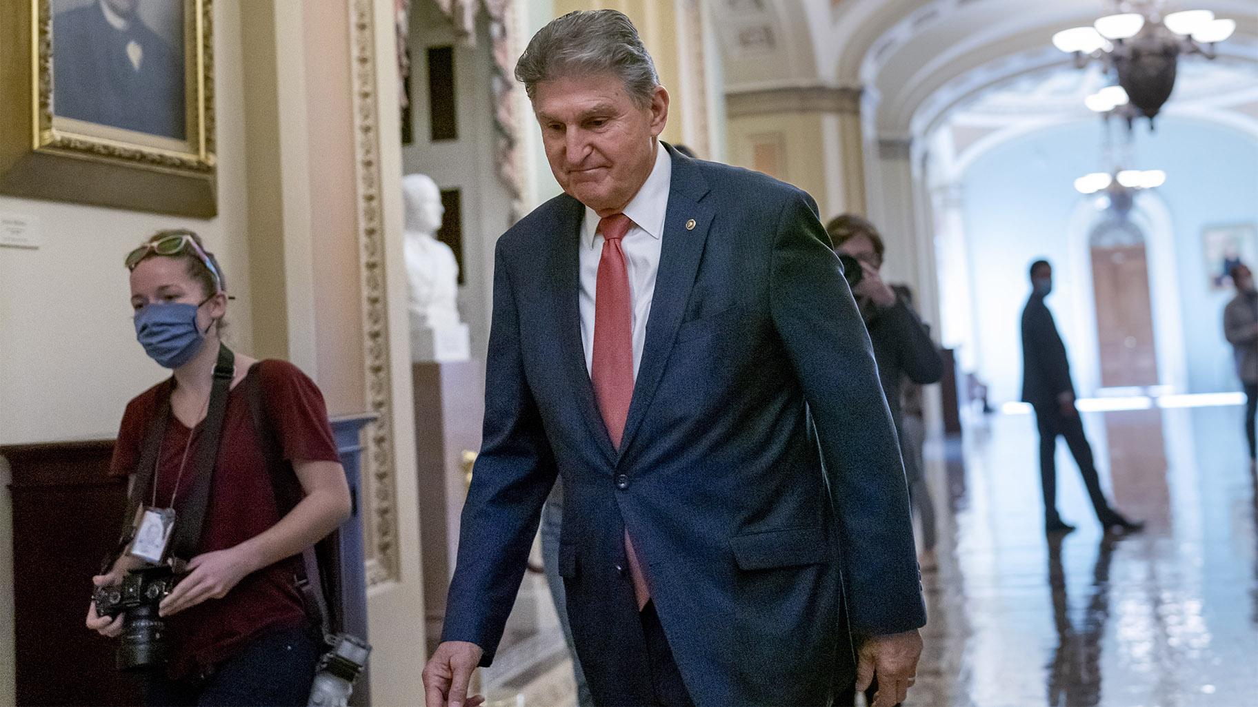 Sen. Joe Manchin, D-W.Va., walks to a caucus lunch at the Capitol in Washington, on Dec. 17, 2021. AP Photo / J. Scott Applewhite, File)