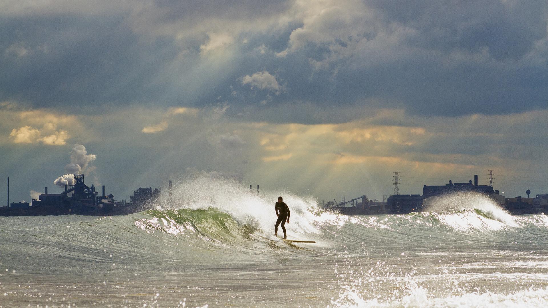 A surfer rides the waves on the south end of Lake Michigan. (Credit: Mike Killion)