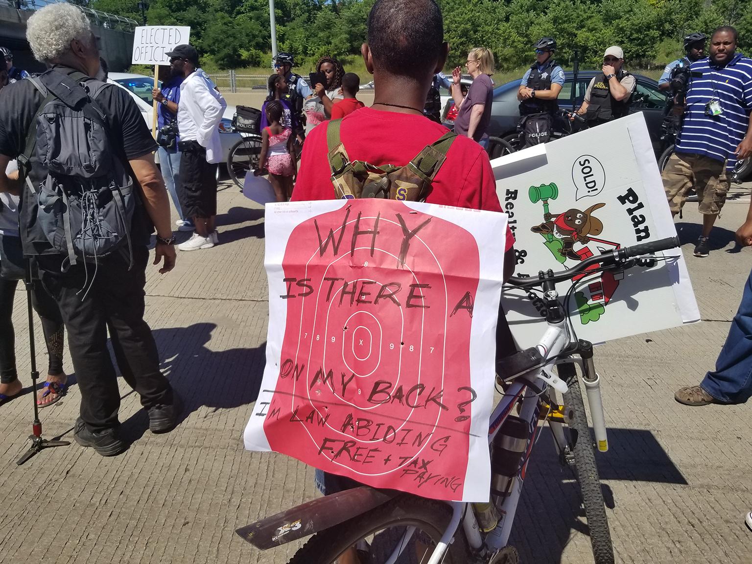 A protester with a "target" on his back stands on the Dan Ryan Expressway. (Matt Masterson / Chicago Tonight)