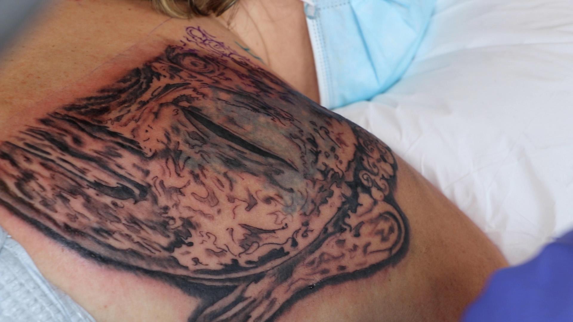 Jennifer Garcia’s tattoo of a dragon from 20 years ago is transformed into a portrait of Buddha by artist Patrick Cornolo, co-owner of Chicago’s Speakeasy Custom Tattoos, on June 22, 2020. (Evan Garcia / WTTW News)