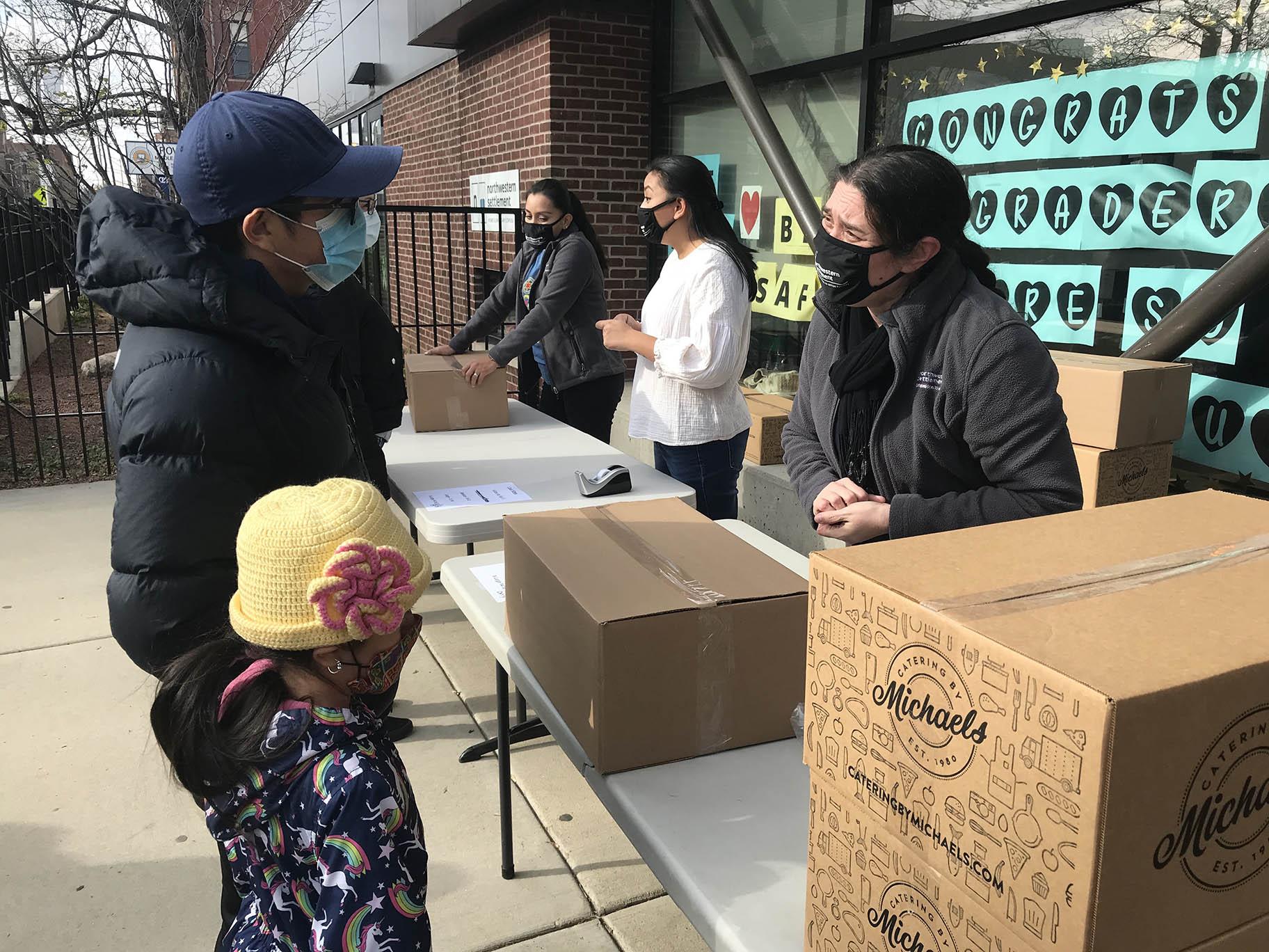 Families pick up Thanksgiving meal boxes and coats for their children at West Town nonprofit Northwestern Settlement on Saturday, Nov. 21, 2020. (Ariel Parrella-Aureli / WTTW News)