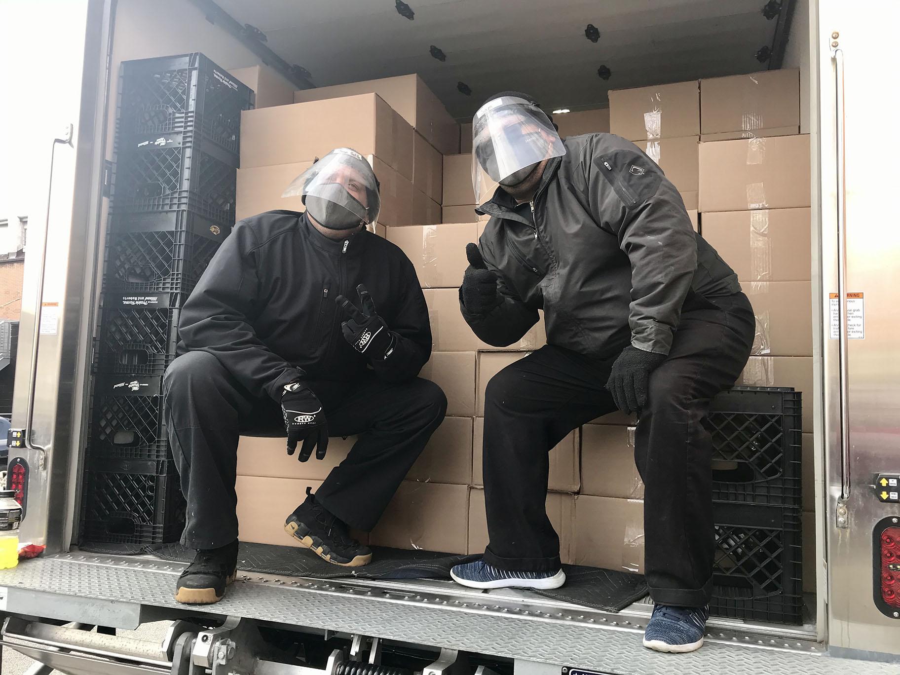 Catering by Michaels delivery truck drivers Sam Espada and Jose Padilla pose for a photo on Saturday, Nov. 21, 2020. (Ariel Parrella-Aureli / WTTW News) 