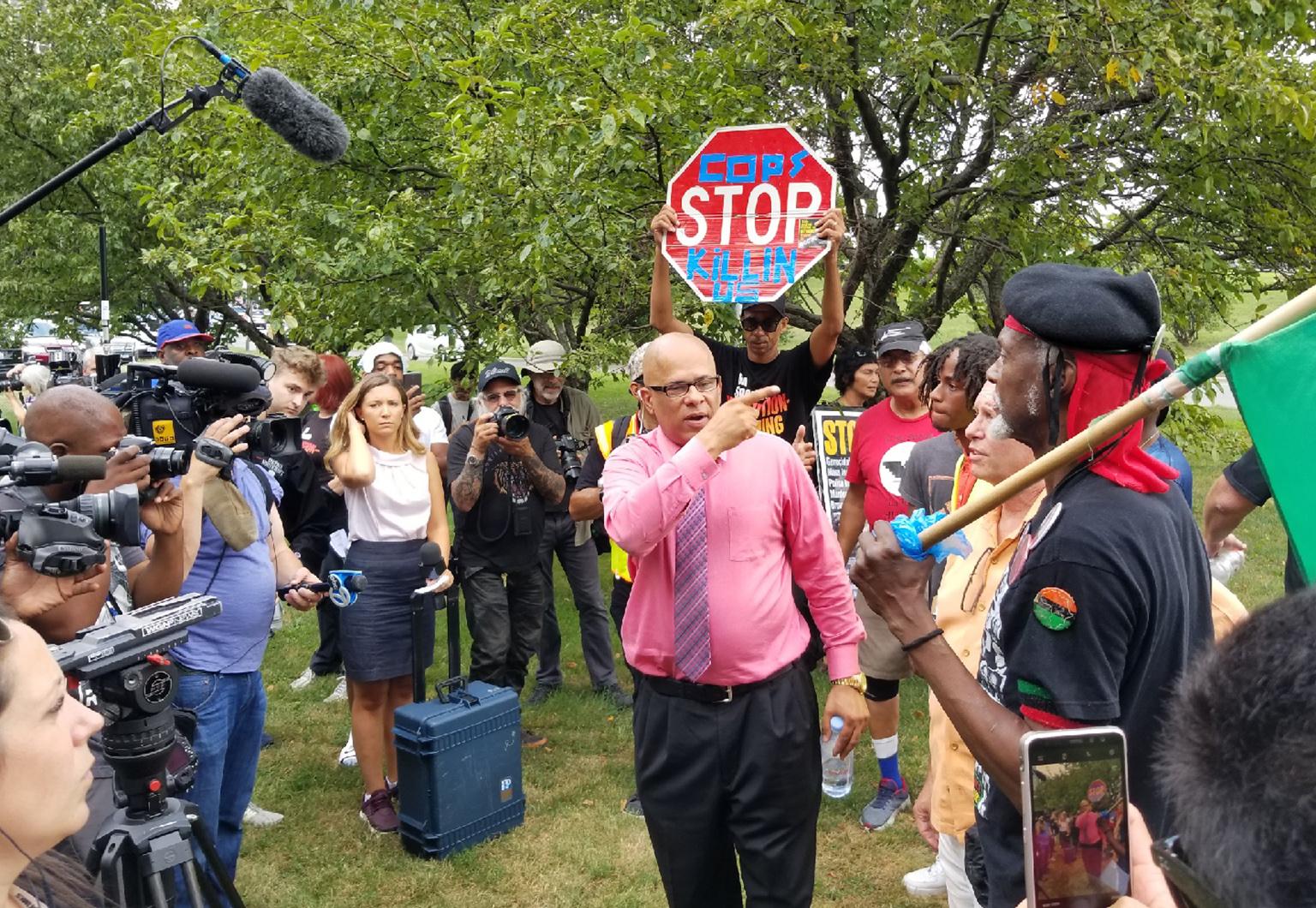 March organizer Tio Hardiman begins to gather protesters near southbound Lake Shore Drive on Thursday afternoon ahead of the planned 4 p.m. start. (Matt Masterson / Chicago Tonight)