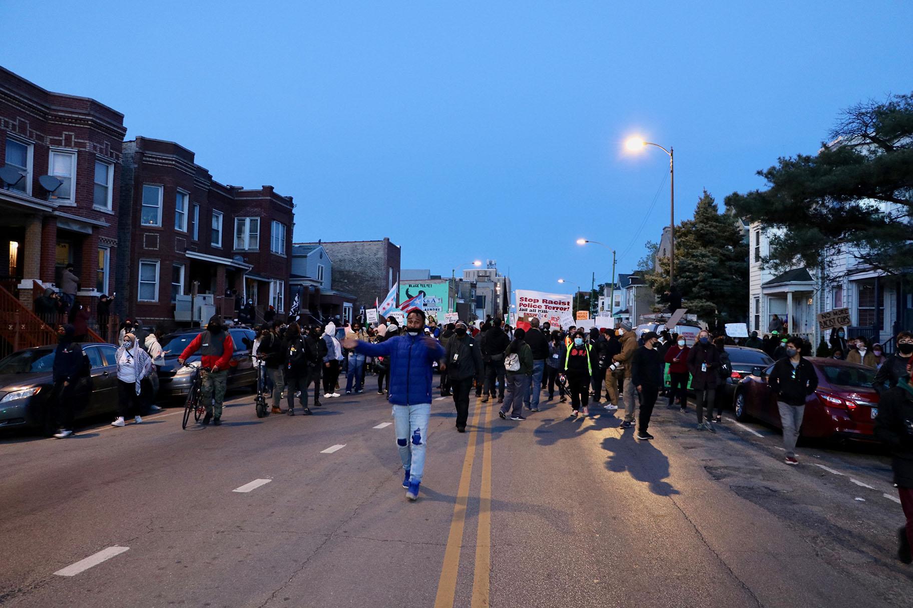 Demonstrators march through the Logan Square neighborhood April 16, 2021, to protest the fatal police shooting of 13-year-old Adam Toledo. (Evan Garcia / WTTW News)