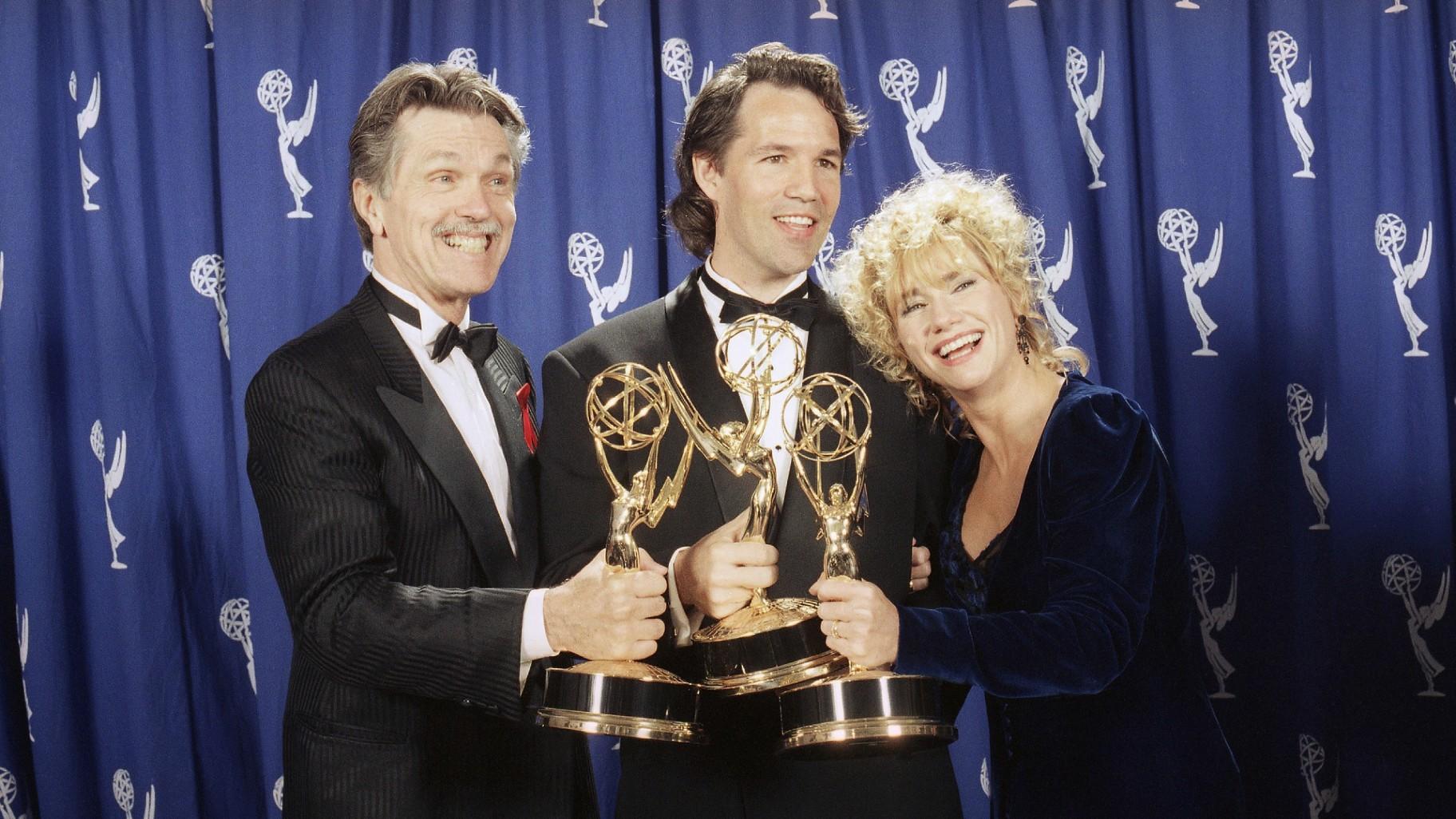FILE - David E. Kelley, center, creator of "Picket Fences," poses with actors Tom Skerritt, left, and Kathy Baker after show won best drama series during the 45th annual Emmy Awards in Pasadena, Calif., on Sept. 19, 1993. (AP Photo / Douglas C. Pizac, File)