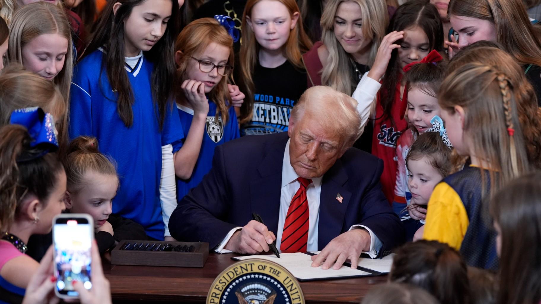 President Donald Trump signs an executive order barring transgender female athletes from competing in women's or girls' sporting events, in the East Room of the White House, Feb. 5, 2025, in Washington. (AP Photo / Alex Brandon, file)