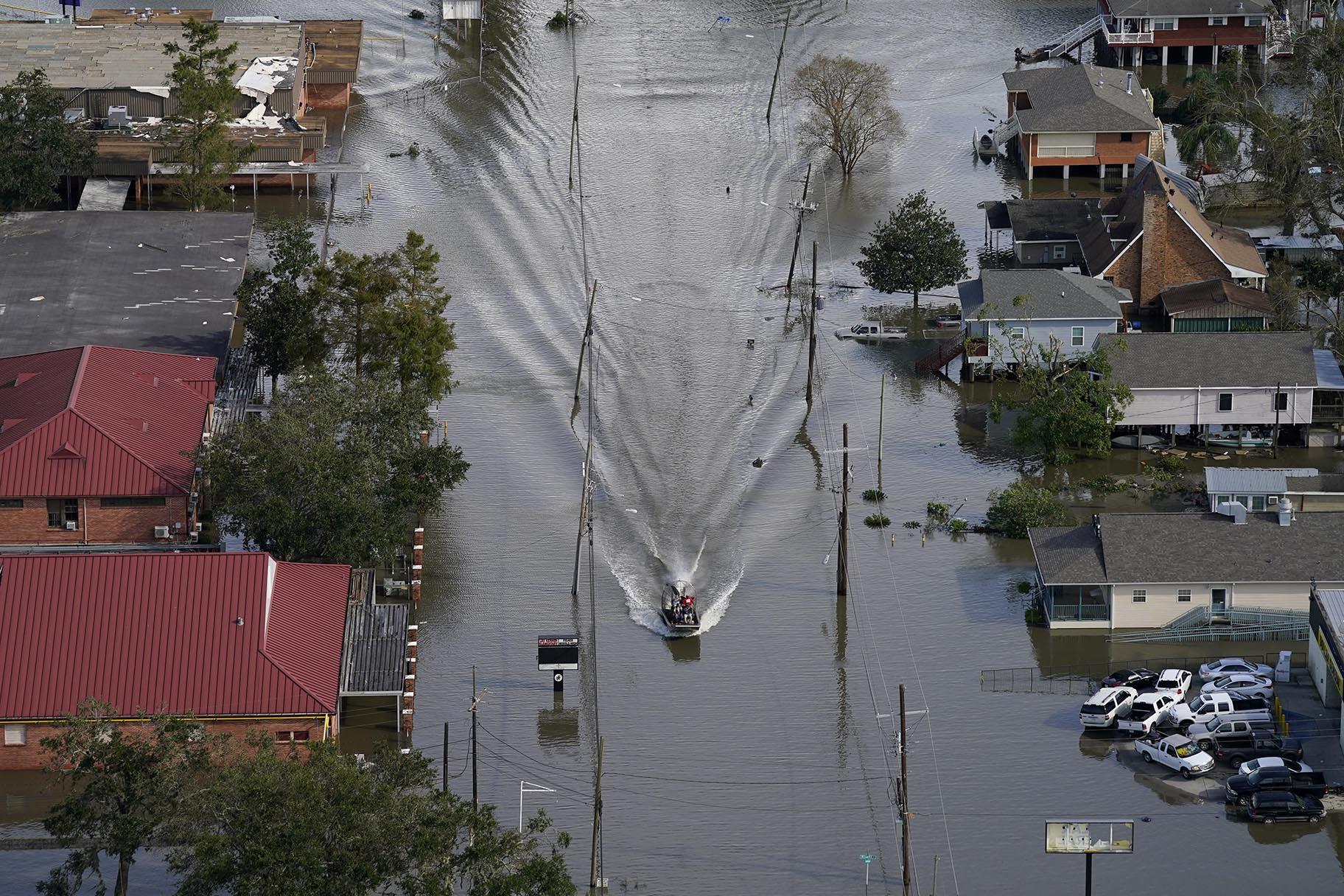 An Airboat glides over a city street in the aftermath of Hurricane Ida, Monday, Aug. 30, 2021, in Lafitte, La. (AP Photo / David J. Phillip)