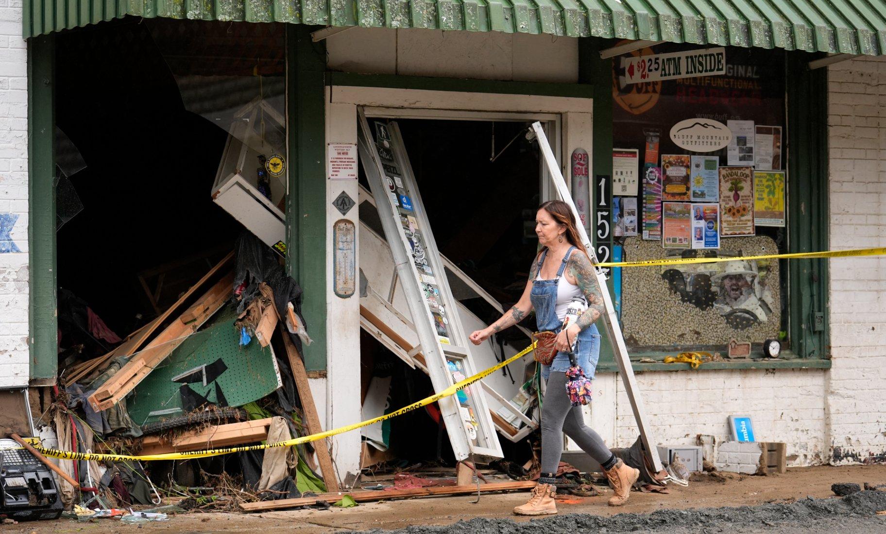 A person walks past a building heavily damaged during Hurricane Helene Tuesday, Oct. 1, 2024, in Hot Springs, N.C. (AP Photo / Jeff Roberson)