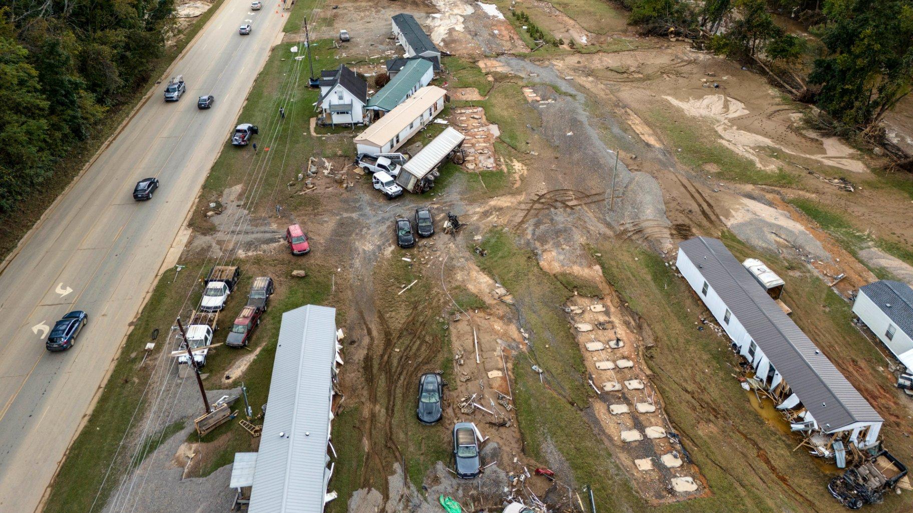 Homes and vehicles that were damaged in a flash flood from Hurricane Helene lie on the side of a road near the Swannanoa River, Tuesday, Oct. 1, 2024, in Swannanoa, N.C. (AP Photo / Mike Stewart)