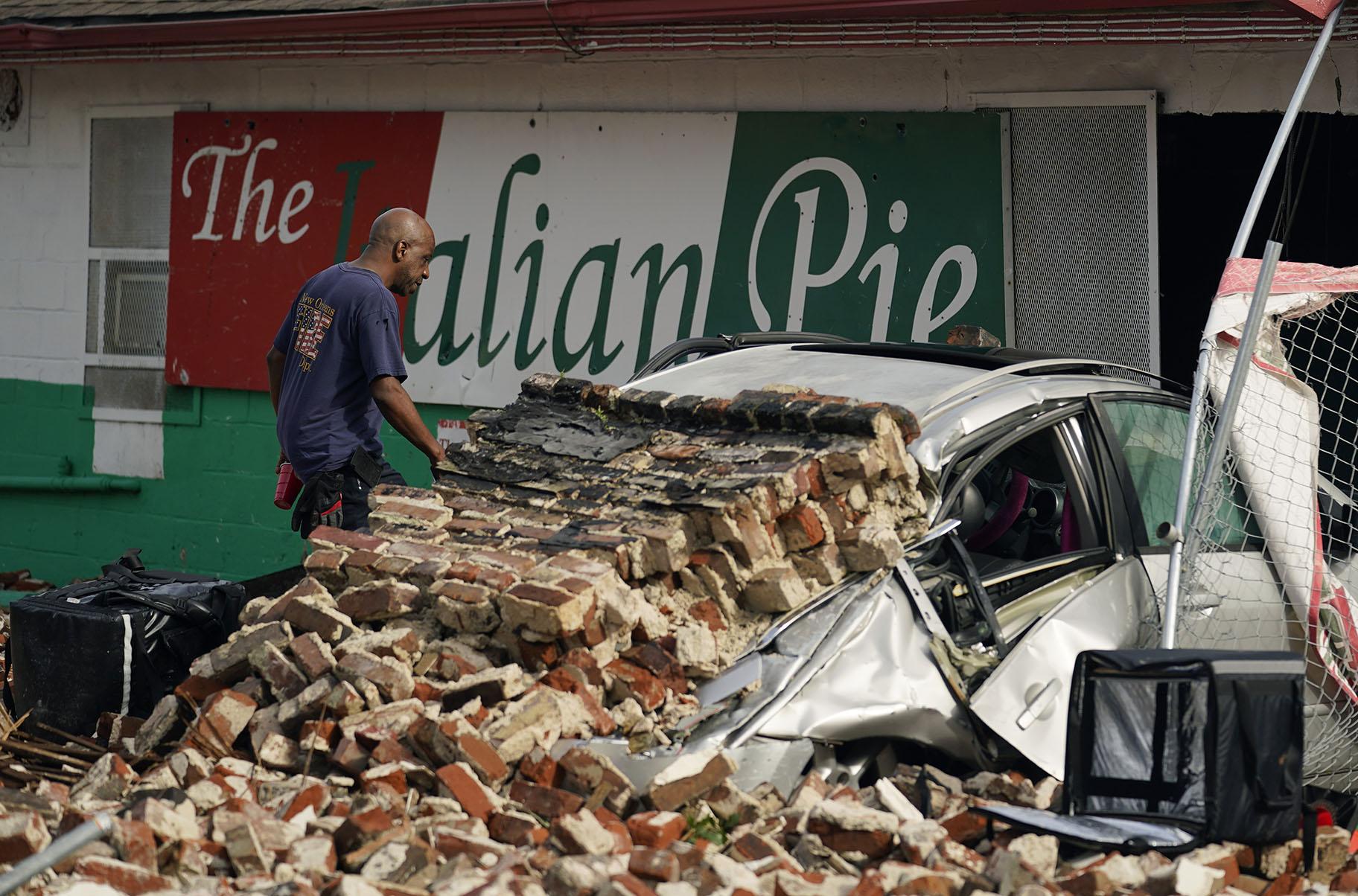 New Orleans Firefighters assess damages as they look through debris after a building collapsed from the effects of Hurricane Ida, Monday, Aug. 30, 2021, in New Orleans, La. (AP Photo / Eric Gay)