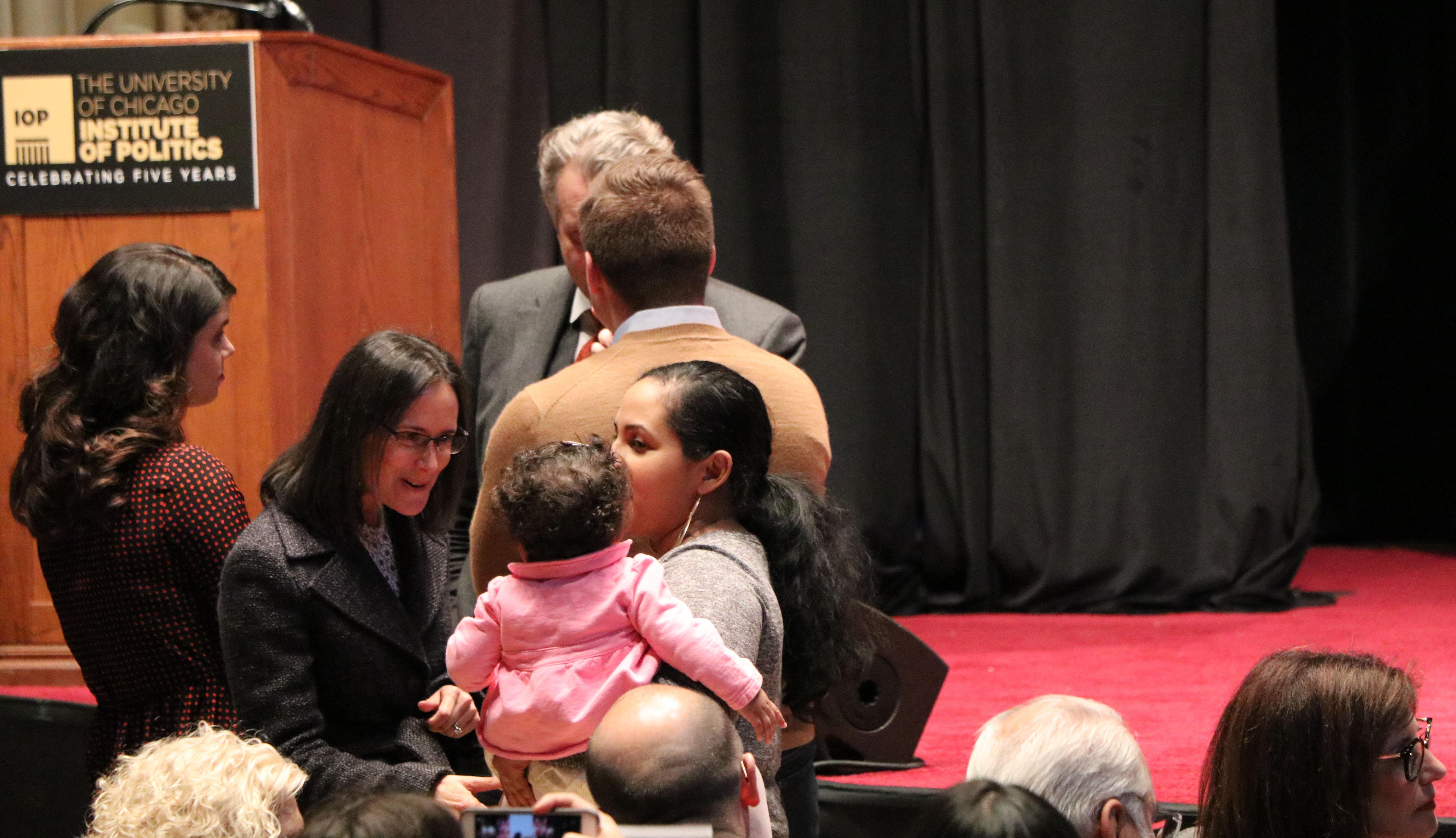 Illinois Attorney General Lisa Madigan, who will not seek reelection this year, speaks to an attendee's young child before the start of Wednesday's event. (Evan Garcia / Chicago Tonight)