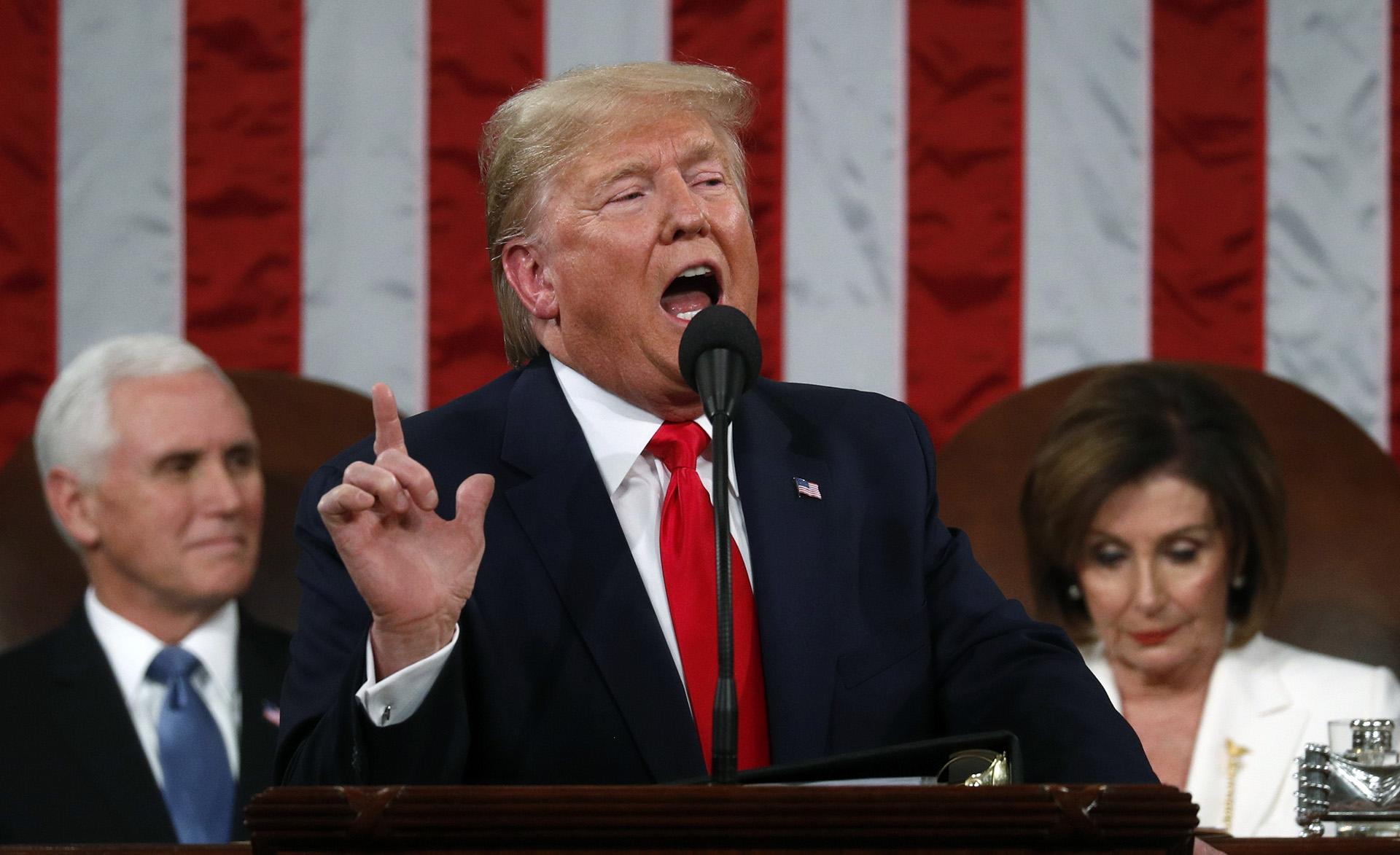 President Donald Trump delivers his State of the Union address to a joint session of Congress in the House Chamber on Capitol Hill in Washington, Tuesday, Feb. 4, 2020, as Vice President Mike Pence and Speaker Nancy Pelosi look on. (Leah Millis / Pool via AP)