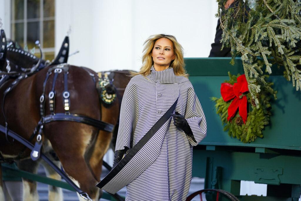 First lady Melania Trump stands next to the 2020 Official White House Christmas tree as it is presented on the North Portico of the White House, Monday, Nov. 23, 2020, in Washington. (AP Photo / Andrew Harnik)