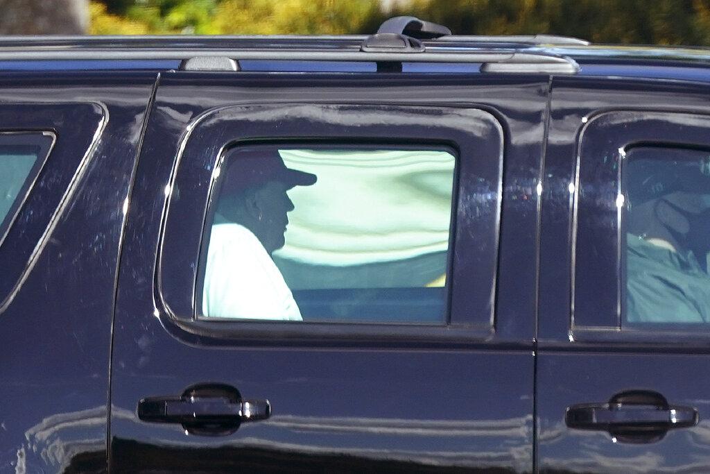 President Donald Trump rides in a motorcade vehicle as he departs Trump International Golf Club, Sunday, Dec. 27, 2020, in West Palm Beach, Fla. (AP Photo / Patrick Semansky)