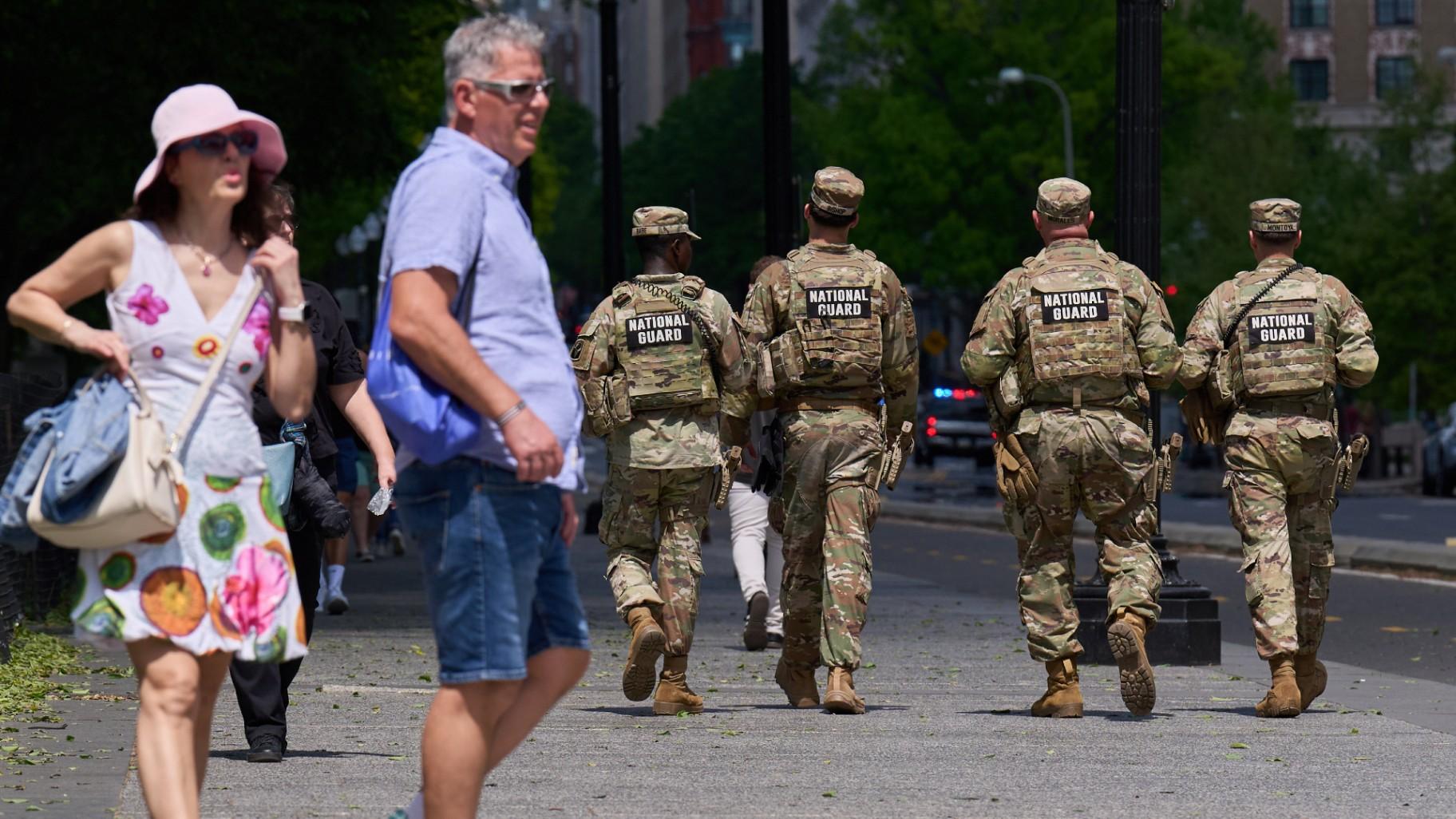 Members of the Florida National Guard pass by tourists on a sidewalk Friday April 17, 2026, in Washington. (AP Photo / Jacquelyn Martin)
