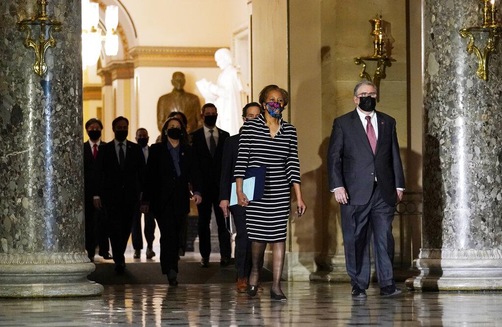 Clerk of the House Cheryl Johnson along with acting House Sergeant-at-Arms Tim Blodgett lead the Democratic House impeachment managers as they walk through Statuary Hall in the Capitol, to deliver to the Senate the article of impeachment alleging incitement of insurrection against former President Donald Trump, Monday, Jan. 25, 2021 in Washington. (AP Photo / Susan Walsh)