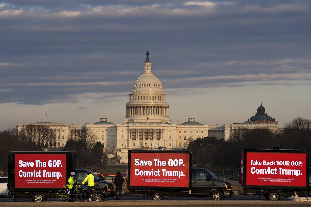 Billboard trucks parked on the National Mall near of the U.S. Capitol during the impeachment trial of former President Donald Trump in Washington, Tuesday, Feb. 9, 2021. (AP Photo / Jose Luis Magana)