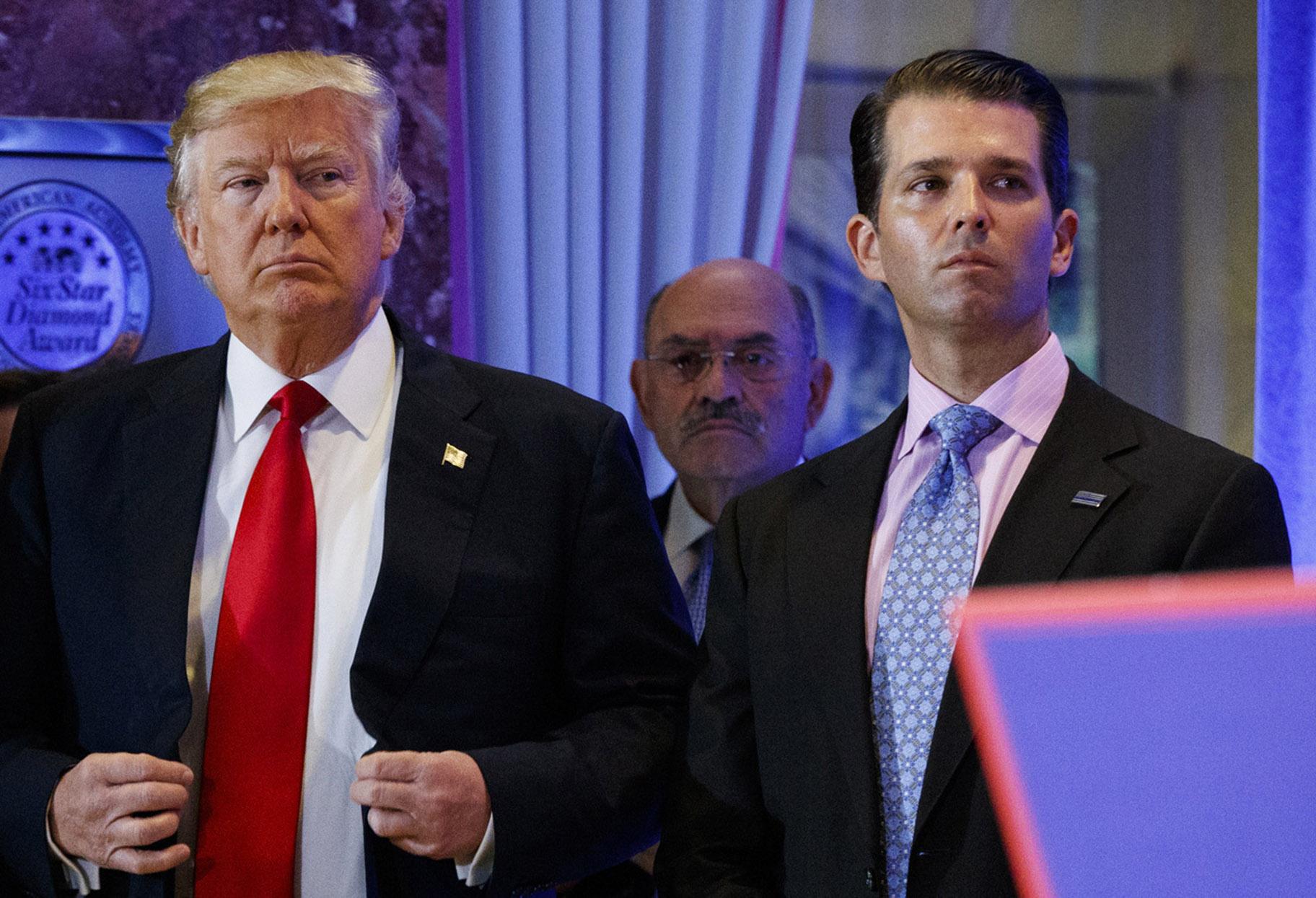 In this Jan. 11, 2017, shows President-elect Donald Trump, left, his chief financial officer Allen Weisselberg, center, and his son Donald Trump Jr., right, attend a news conference in the lobby of Trump Tower in New York. (AP Photo / Evan Vucci, File)