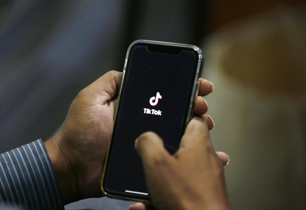 In this July 21, 2020 file photo, a man opens social media app TikTok on his cell phone, in Islamabad, Pakistan. (AP Photo / Anjum Naveed, File)