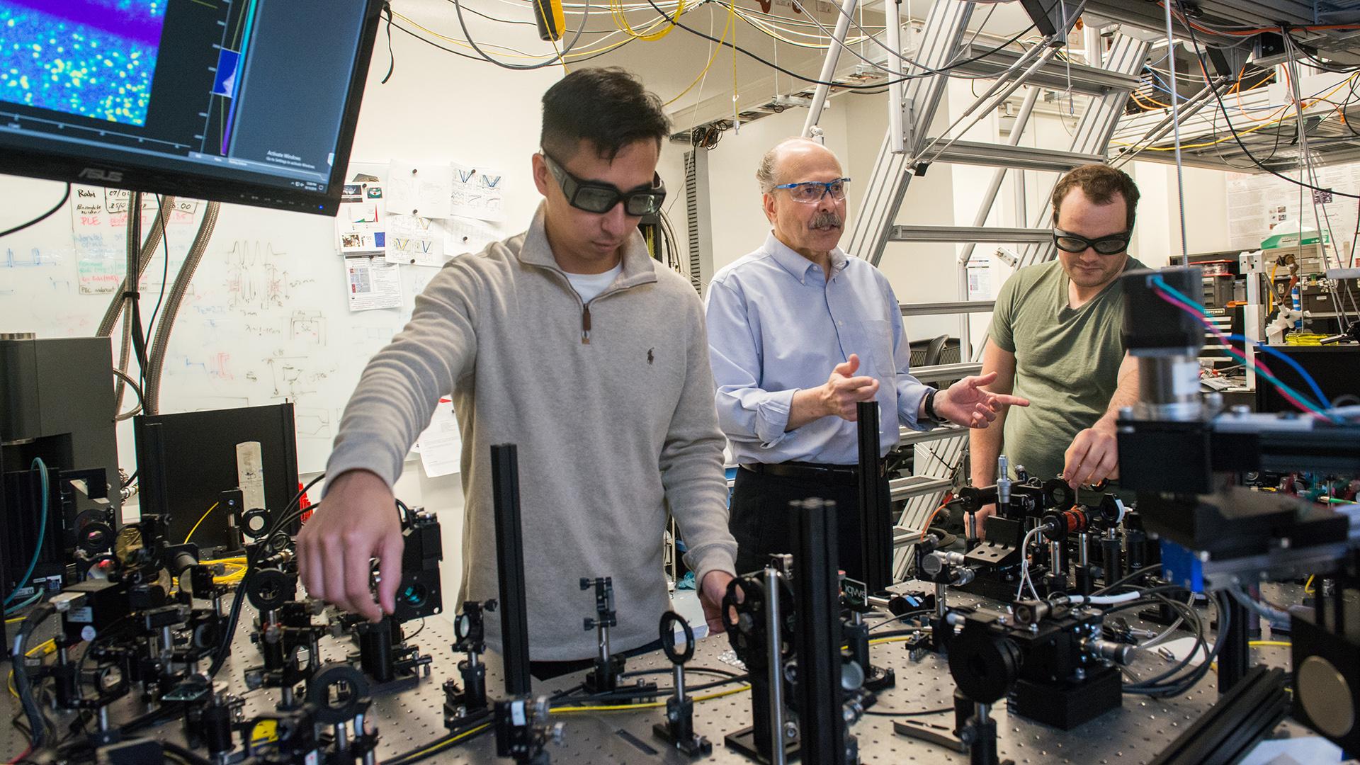 University of Chicago researcher David D. Awschalom in his lab with Ph.D. students Kevin Miao, left, and Alexandre Bourassa, on Oct. 15, 2018. (Photo by Jean Lachat)