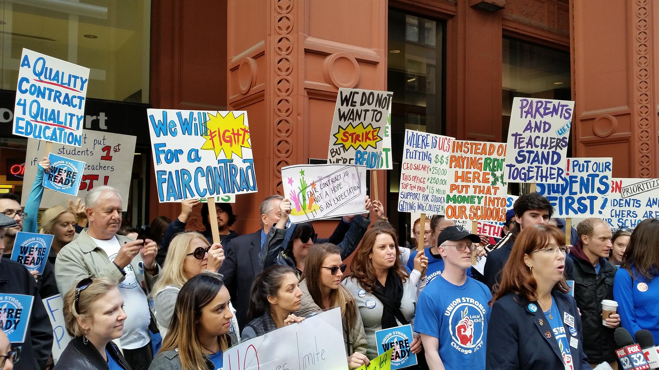 UEU spokeswoman Erica Stewart, far right, joins protestors outside the UNO Charter School Network offices downtown Thursday to call for greater urgency during ongoing labor negotiations. (Matt Masterson / Chicago Tonight)