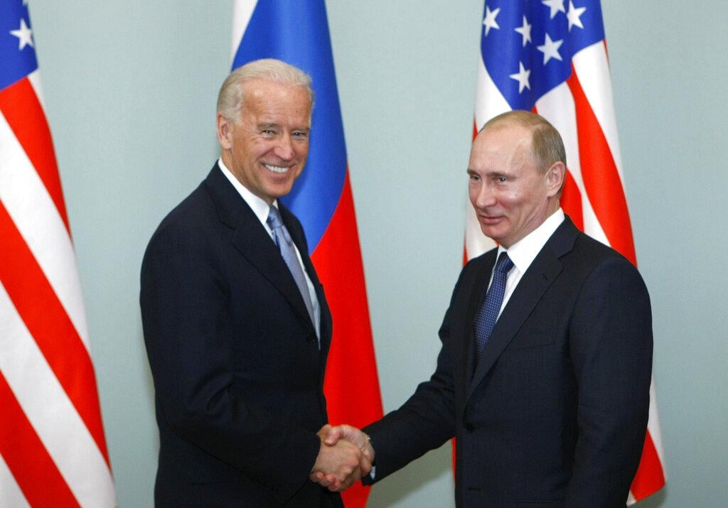 In this March 10, 2011, file photo, then-Vice President Joe Biden, left, shakes hands with Russian Prime Minister Vladimir Putin in Moscow, Russia. (AP Photo / Alexander Zemlianichenko, File)