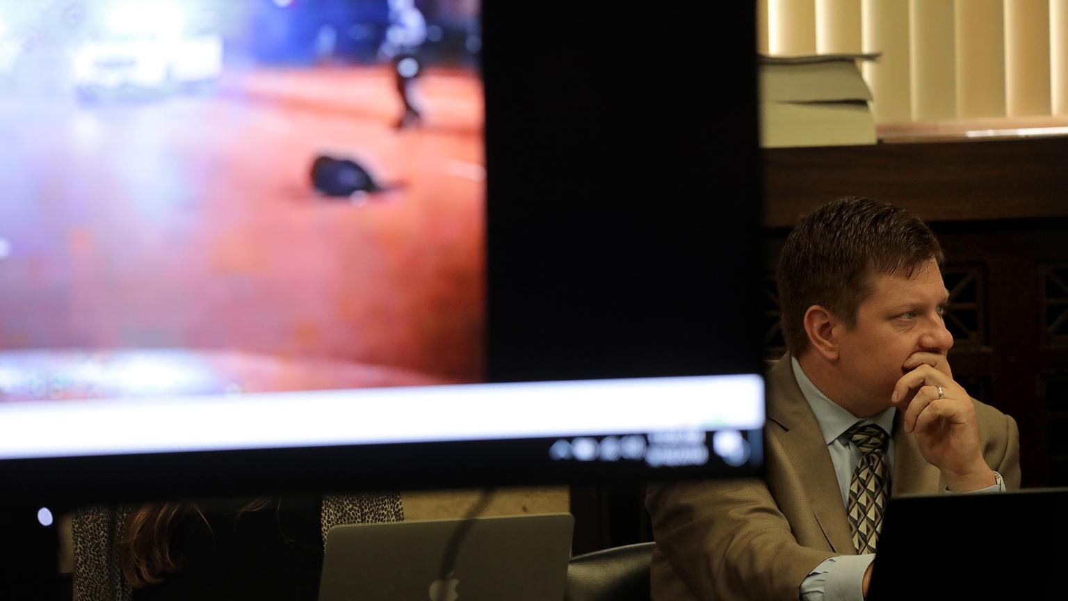 Chicago police Officer Jason Van Dyke listens in as an image showing the shooting death of Laquan McDonald is displayed during the trial on Tuesday, Sept. 18, 2018. (Antonio Perez / Chicago Tribune / Pool)