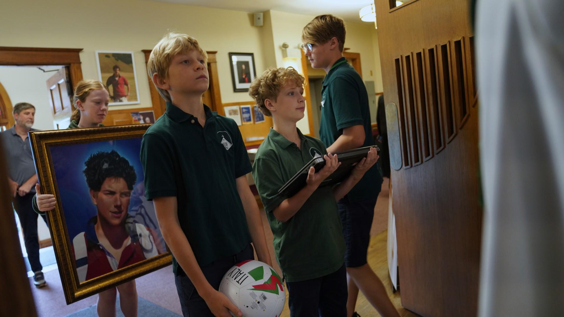 Students of St. John Berchmans’ school hold items often linked to Blessed Carlo Acutis, who will be canonized a saint by Pope Leo XIV, before Mass at Blessed Carlo Acutis Parish, on Wednesday, Sept. 3, 2025, in Chicago. (AP Photo / Jessie Wardarski)