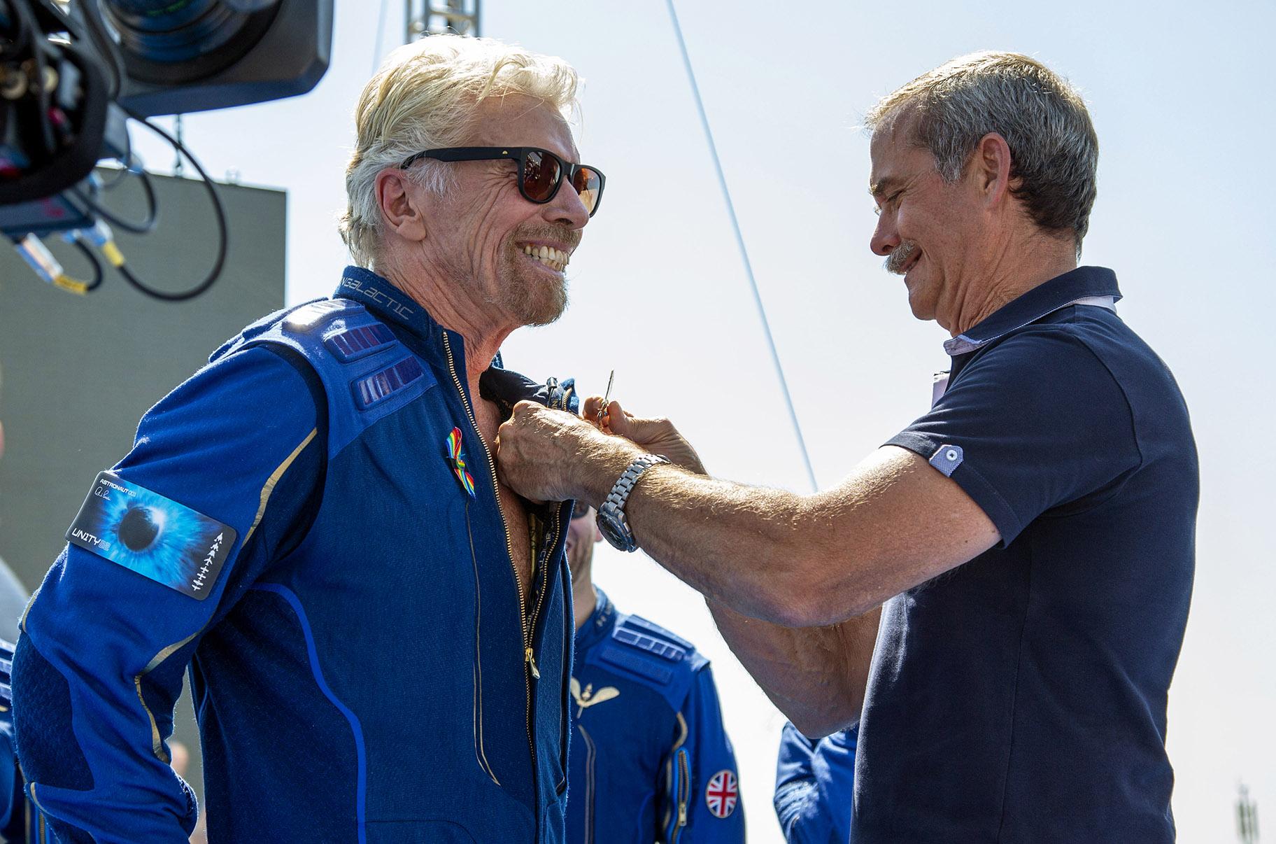 Virgin Galactic founder Richard Branson, left, receives a Virgin Galactic made astronaut wings pin from Canadian astronaut Chris Hadfield after his flight to space from Spaceport America near Truth or Consequences, N.M., Sunday, July 11, 2021. (AP Photo / Andres Leighton)