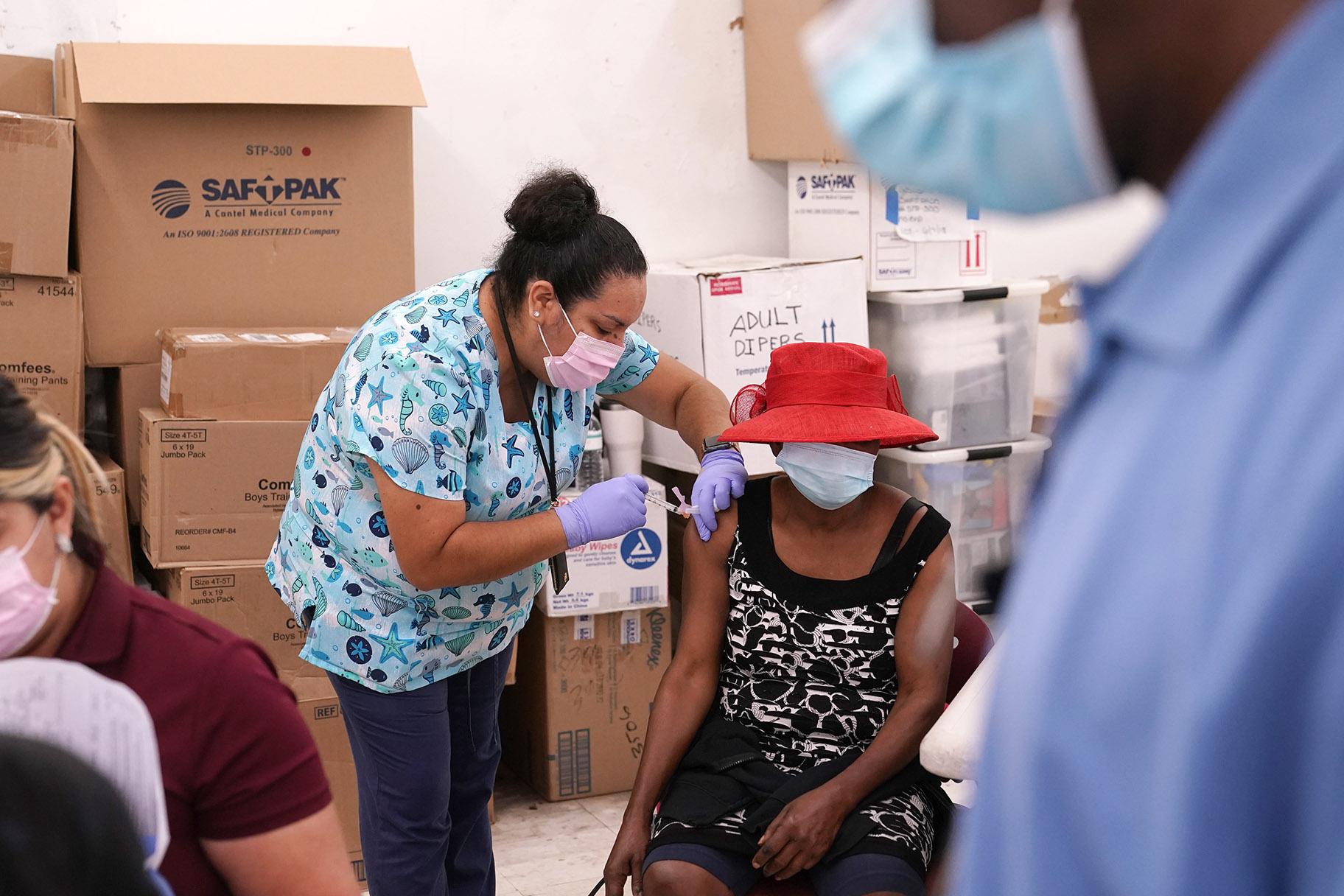 In this April 10, 2021, file photo, registered nurse Ashleigh Velasco, left, administers the Johnson & Johnson COVID-19 vaccine to Rosemene Lordeus, right, at a clinic held by Healthcare Network in Immokalee, Fla. (AP Photo / Lynne Sladky, File)