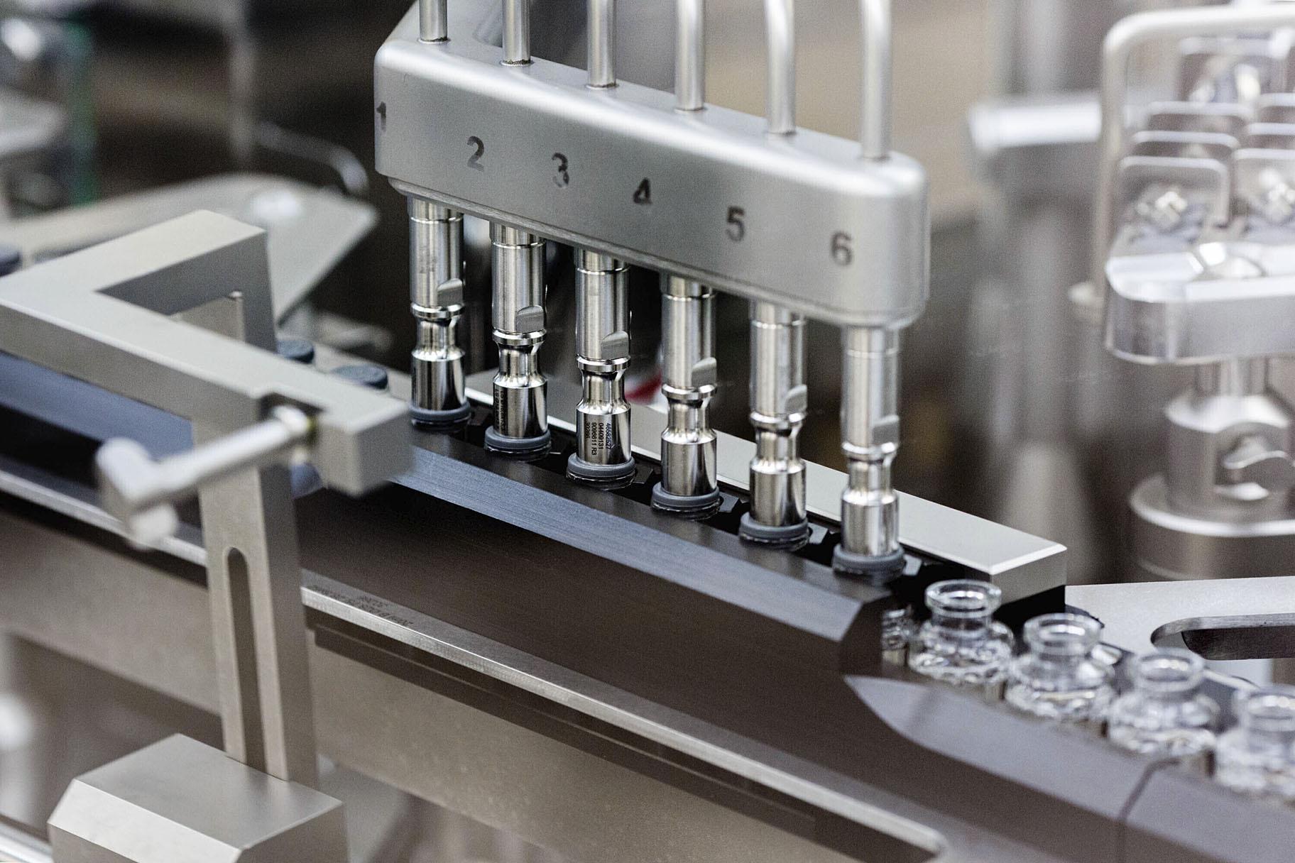 In this March 2020 photo provided by Gilead Sciences, rubber stoppers are placed onto filled vials of the investigational drug remdesivir at a Gilead manufacturing site in the United States. (Gilead Sciences via AP)