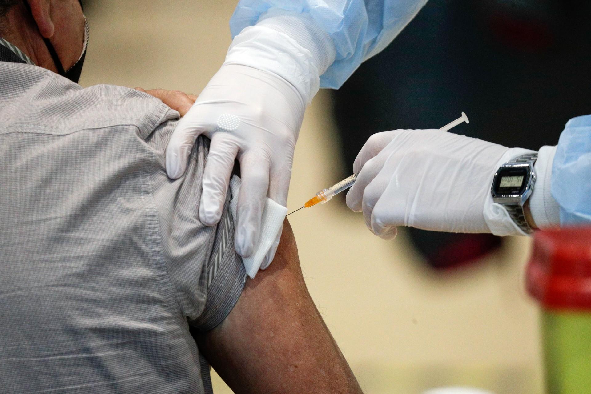 In this Friday, March 19, 2021 file photo Medical staff members administer the AstraZeneca vaccine at La Nuvola (The Cloud) convention center that was temporarily turned into a COVID-19 vaccination hub, in Rome. (AP Photo / Gregorio Borgia)