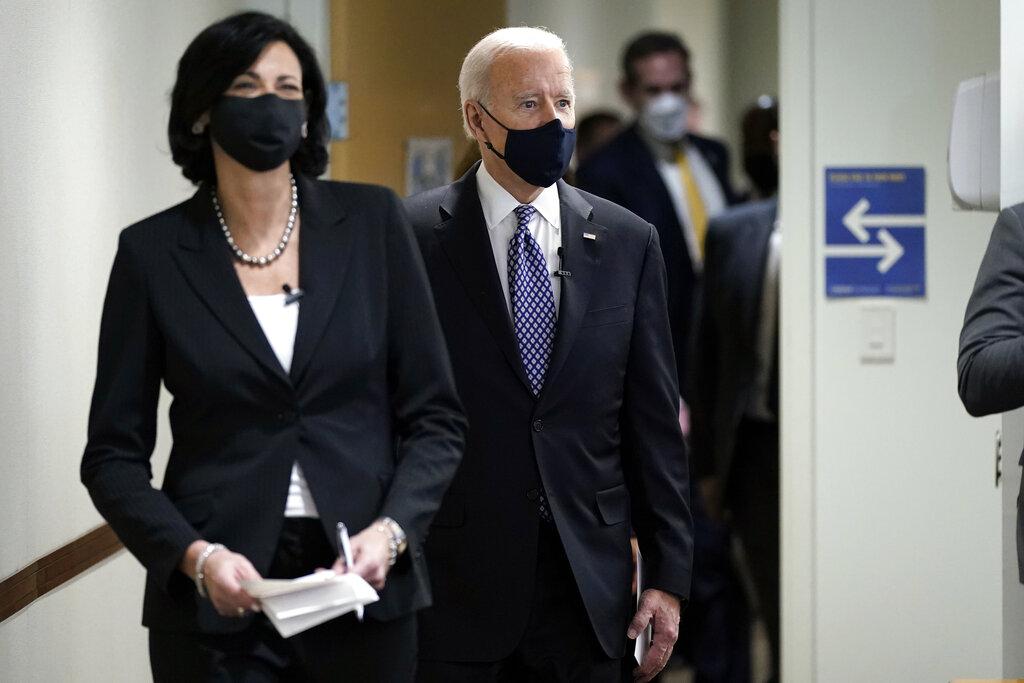 In this March 19, 2021, photo, Dr. Rochelle Walensky, director of the Centers for Disease Control and Prevention, leads President Joe Biden into the room for a COVID-19 briefing at the headquarters for the CDC Atlanta. (AP Photo / Patrick Semansky)