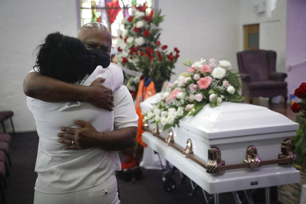 In this July 21, 2020, file photo, Darryl Hutchinson, facing camera, is hugged by a relative during a funeral service for Lydia Nunez, who was Hutchinson’s cousin at the Metropolitan Baptist Church in Los Angeles. Nunez died from COVID-19. (AP Photo / Marcio Jose Sanchez, File)