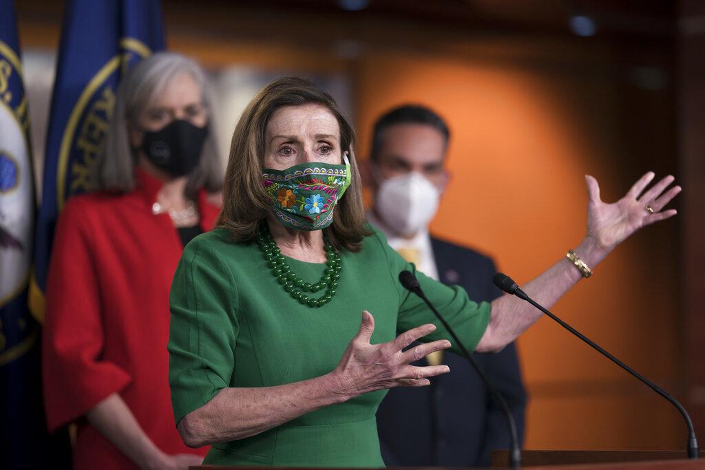 Speaker of the House Nancy Pelosi, D-Calif., meets with reporters before the House votes to pass a .9 trillion pandemic relief package, during a news conference at the Capitol in Washington, Friday, Feb. 26, 2021. Pelosi is flanked by Rep. Katherine Clark, D-Mass., left, and Rep. Pete Aguilar, D-Calif. (AP Photo / J. Scott Applewhite)