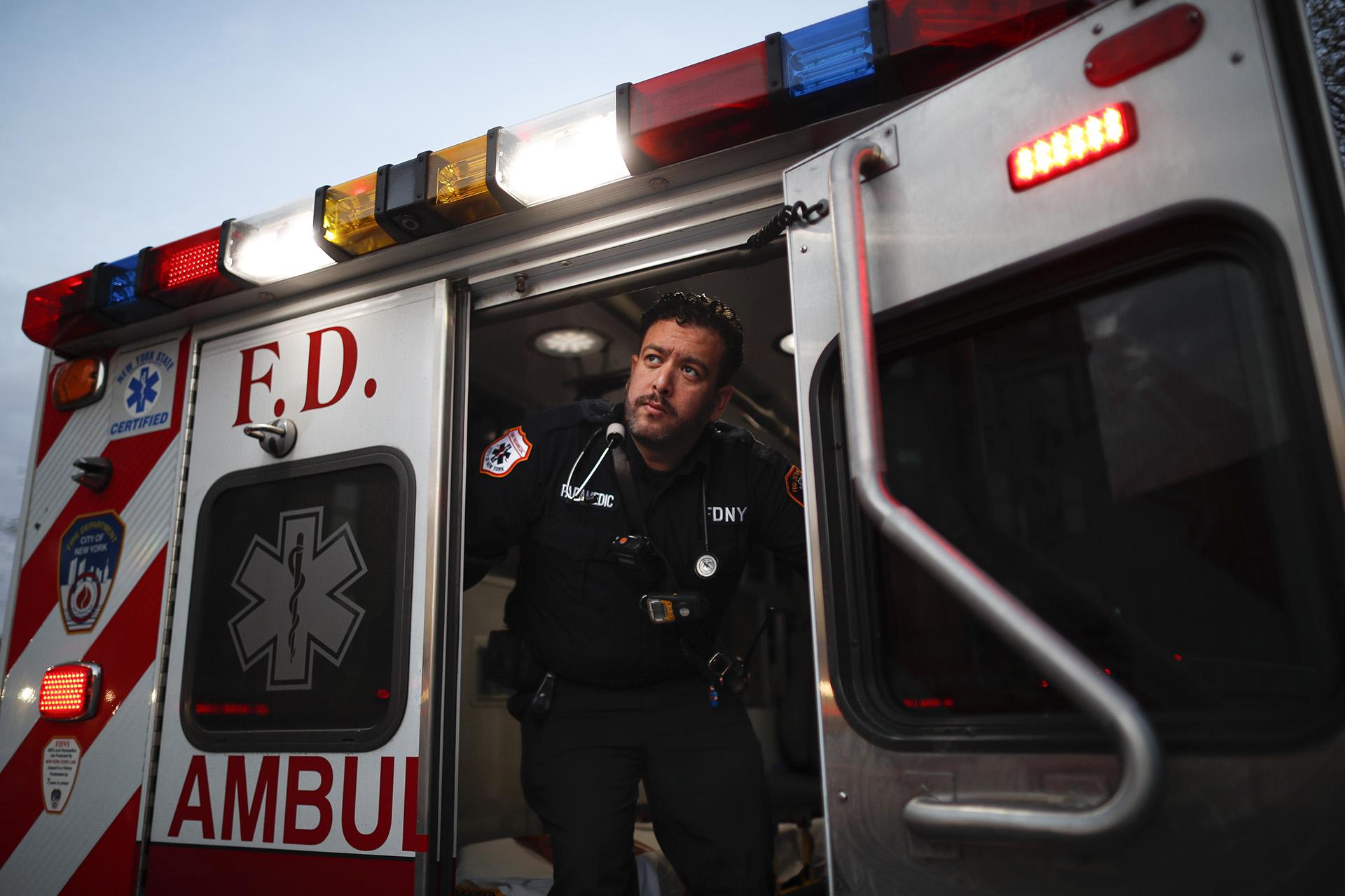 In this April 23, 2020, photo FDNY paramedic Alex Tull, who has recently recovered from COVID-19, prepares to begin his shift outside EMS station 26, the “Tinhouse”, in the Bronx borough of New York. (AP Photo / John Minchillo)