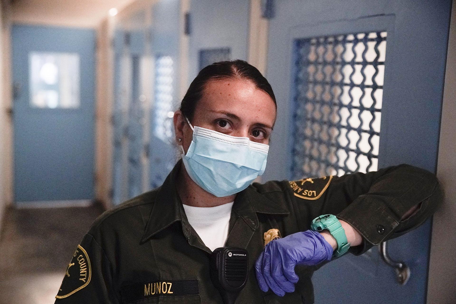 In this April 16, 2020, photo Sonia Munoz, a custody assistant, poses for a picture at the hospital ward of the Twin Towers jail in Los Angeles. Across the country first responders who’ve fallen ill from COVID-19, recovered have begun the harrowing experience of returning to jobs that put them back on the front lines of America's fight against the novel coronavirus. (AP Photo / Chris Carlson)